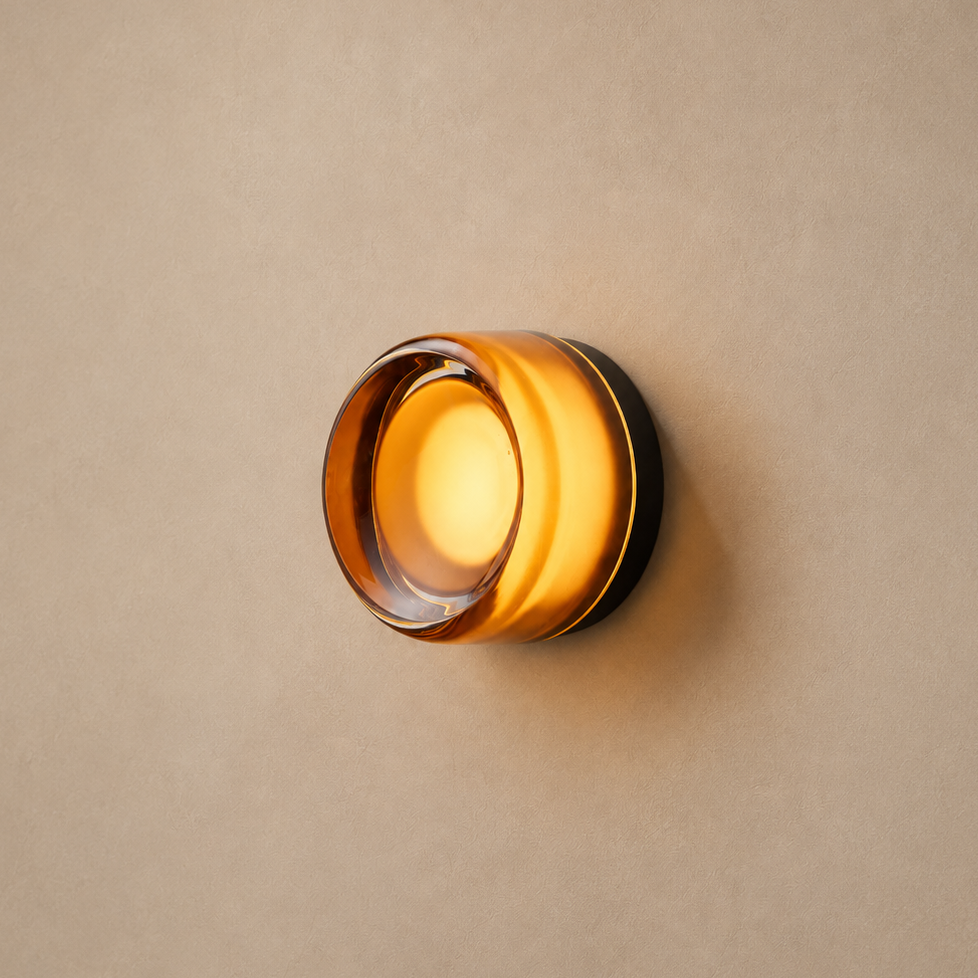 The Halo, domed aluminium wall light with an amber diffuser, lit — Selden Home product photography