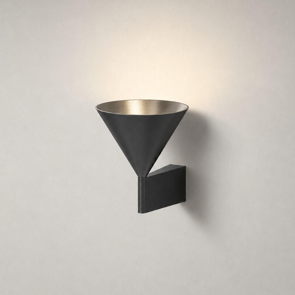 The Funnel, brushed aluminium cone wall light throwing a warm beam down the wall — Selden Home product photography