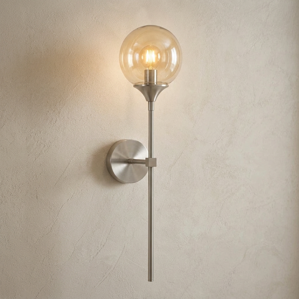The Reed, silver long-stem wall sconce with amber glass globe, mounted on plaster wall — Selden Home product photography