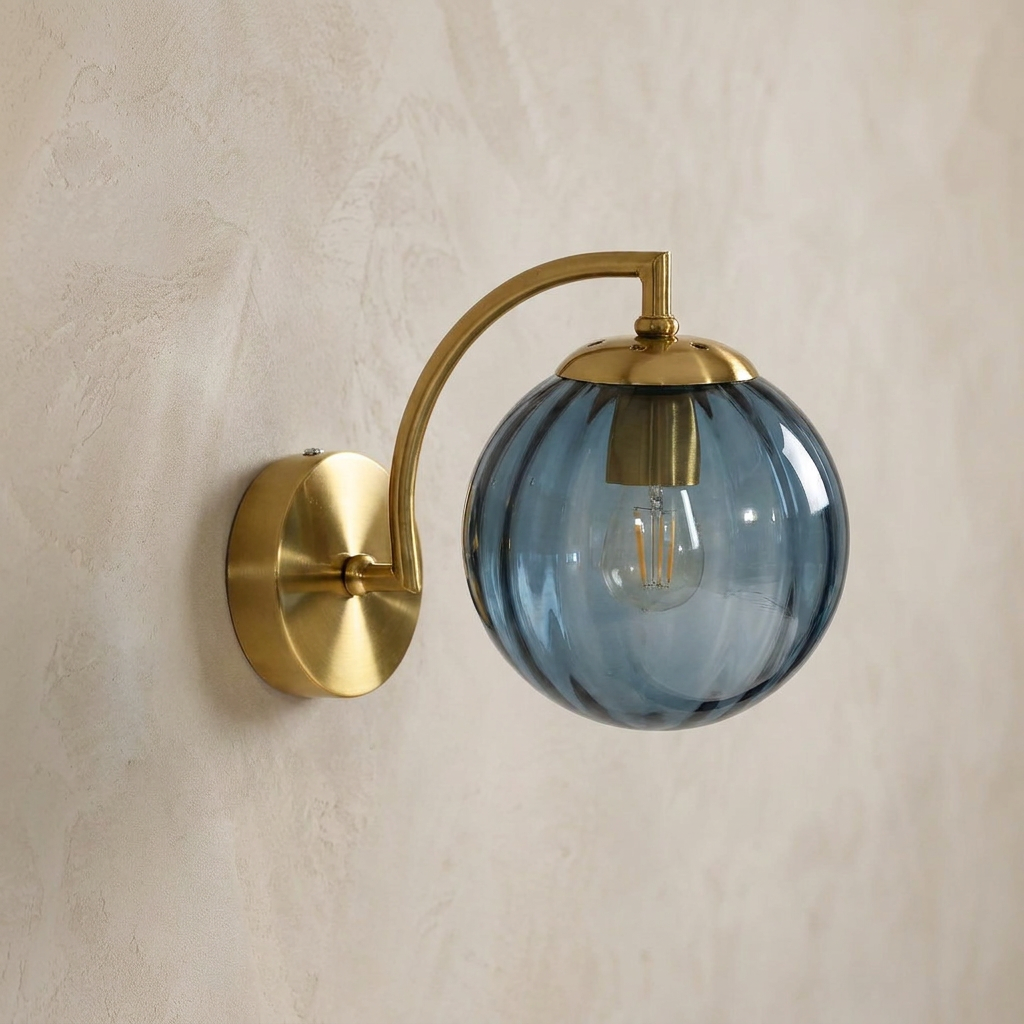 The Bloom, ribbed glass wall sconce, blue glass on gold arm, mounted on plaster wall — Selden Home product photography