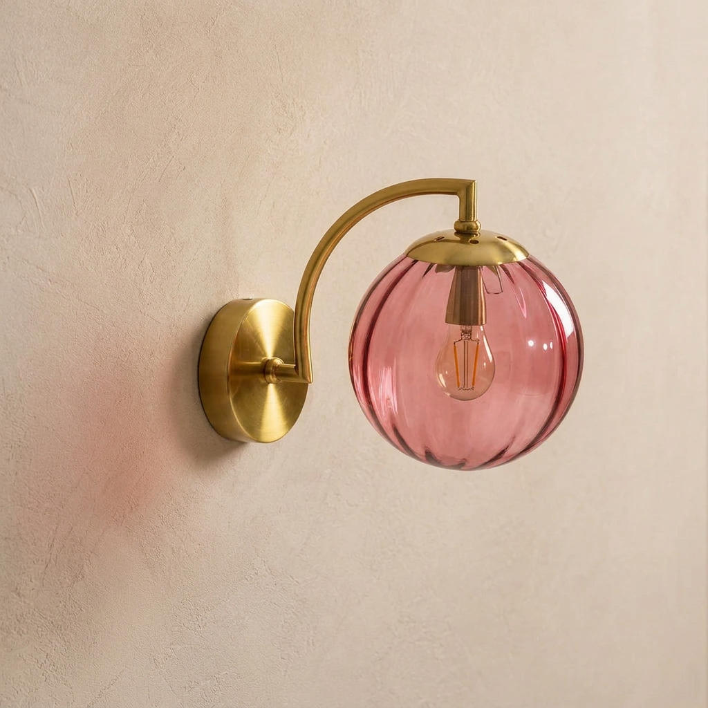 The Bloom, ribbed glass wall sconce, rose red glass on gold arm, mounted on plaster wall — Selden Home product photography