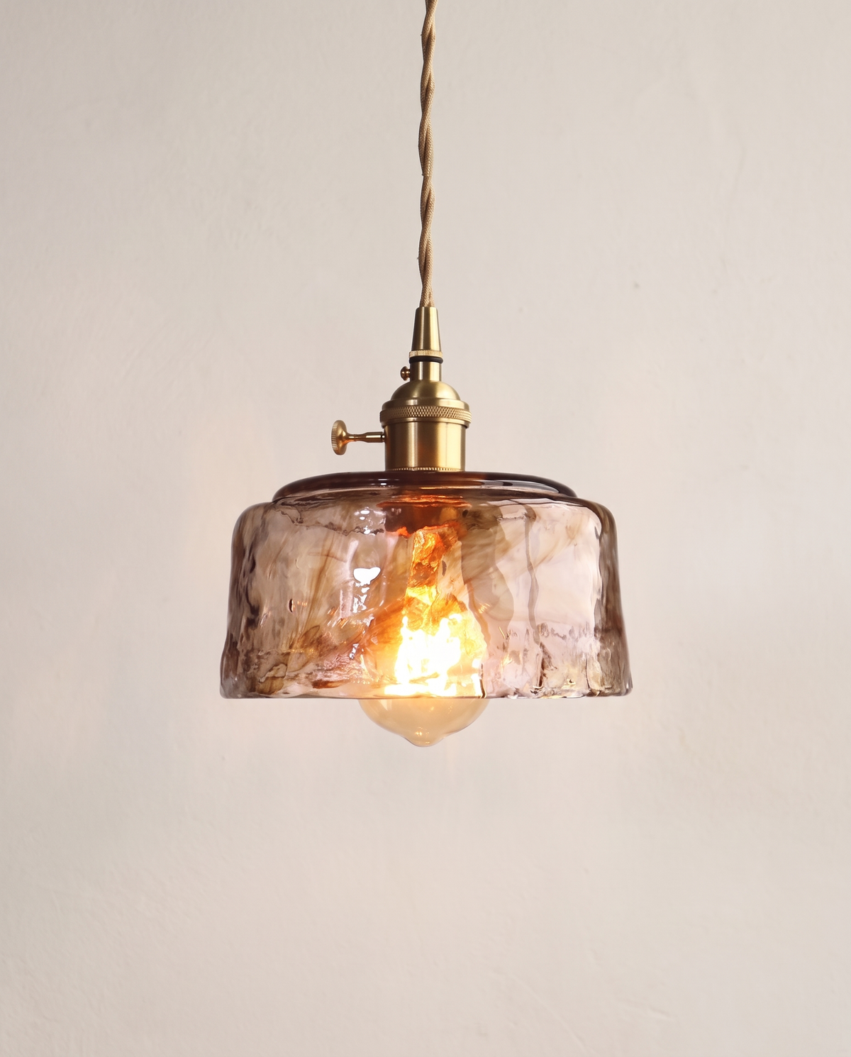 The Tumbler Pendant – Dome, textured amber glass with a brass holder