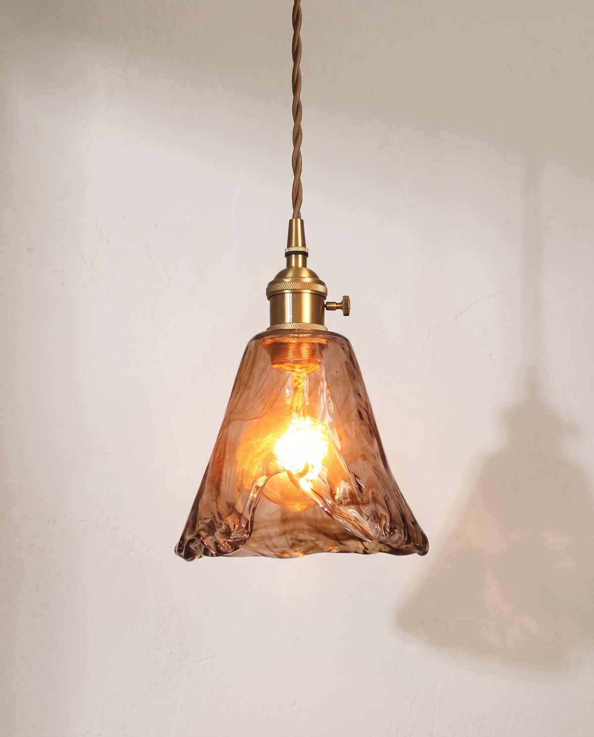 The Tumbler Pendant – Teardrop, textured amber glass with a brass holder