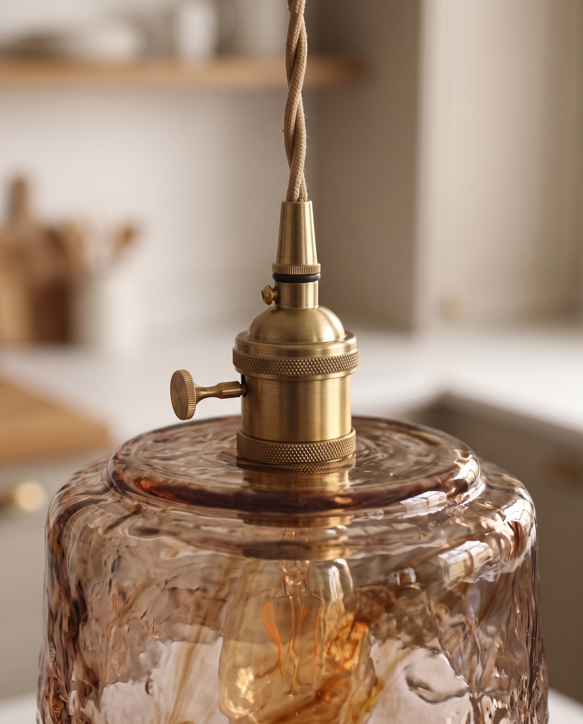 Close-up of The Tumbler's antique brass holder, turn switch and twisted flex