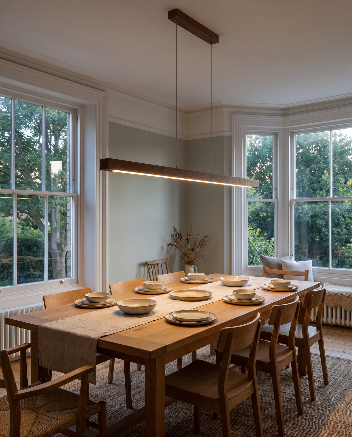 The Joist Pendant in dark wood over a long oak dining table