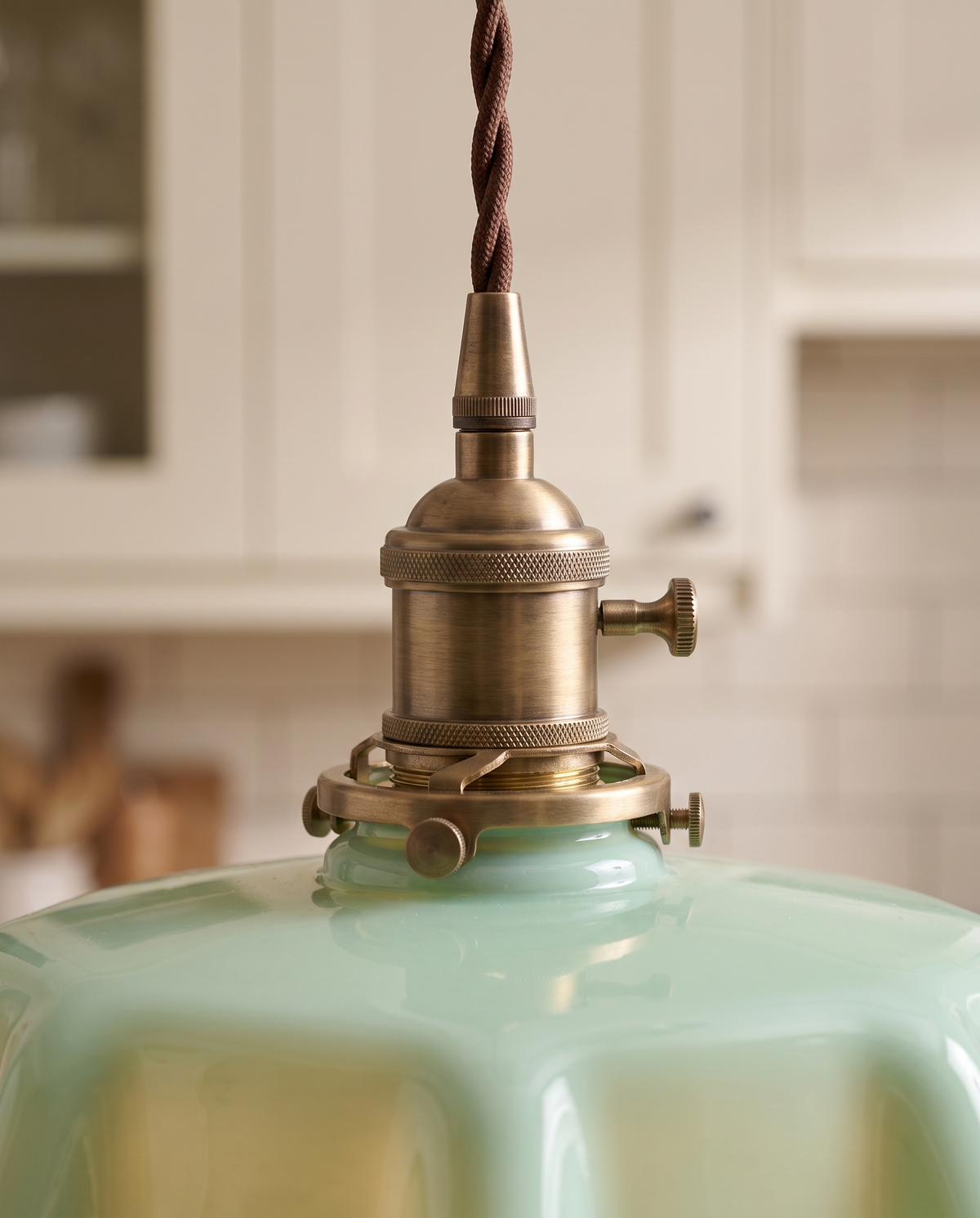 Close-up of The Scallop's aged brass holder and twisted flex