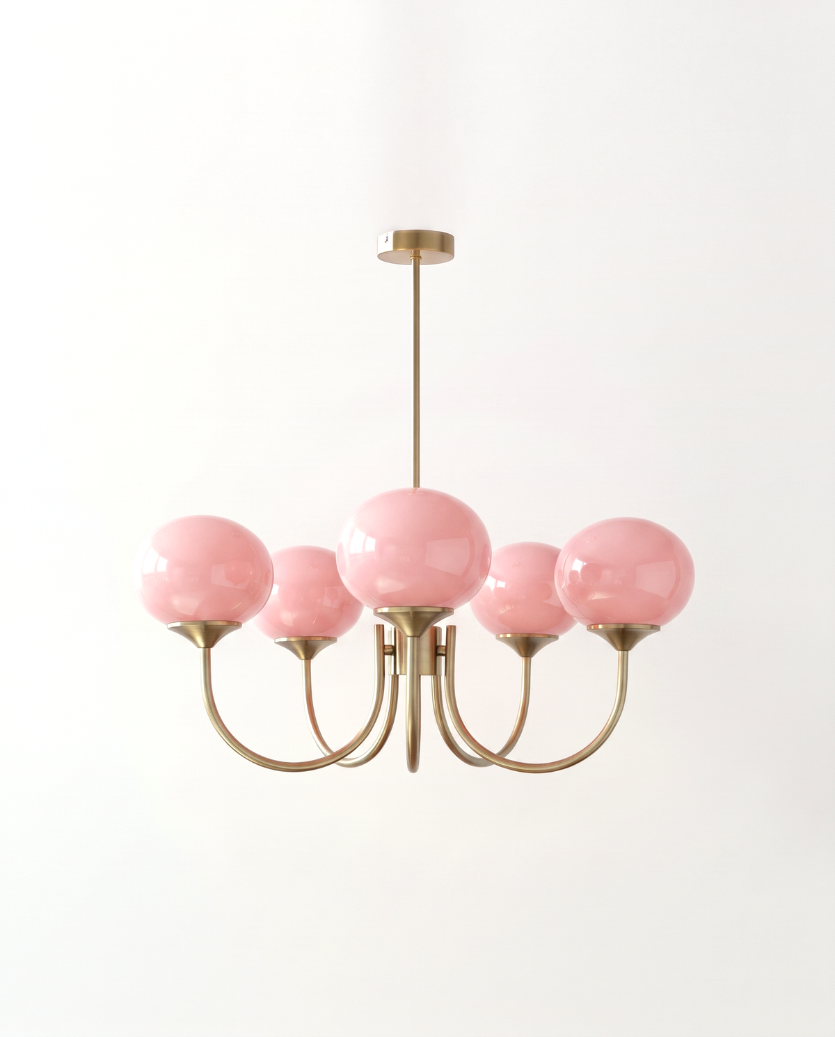 The Bonbon Chandelier in Brass & Rose, five sprayed glass globes on curved arms, lit