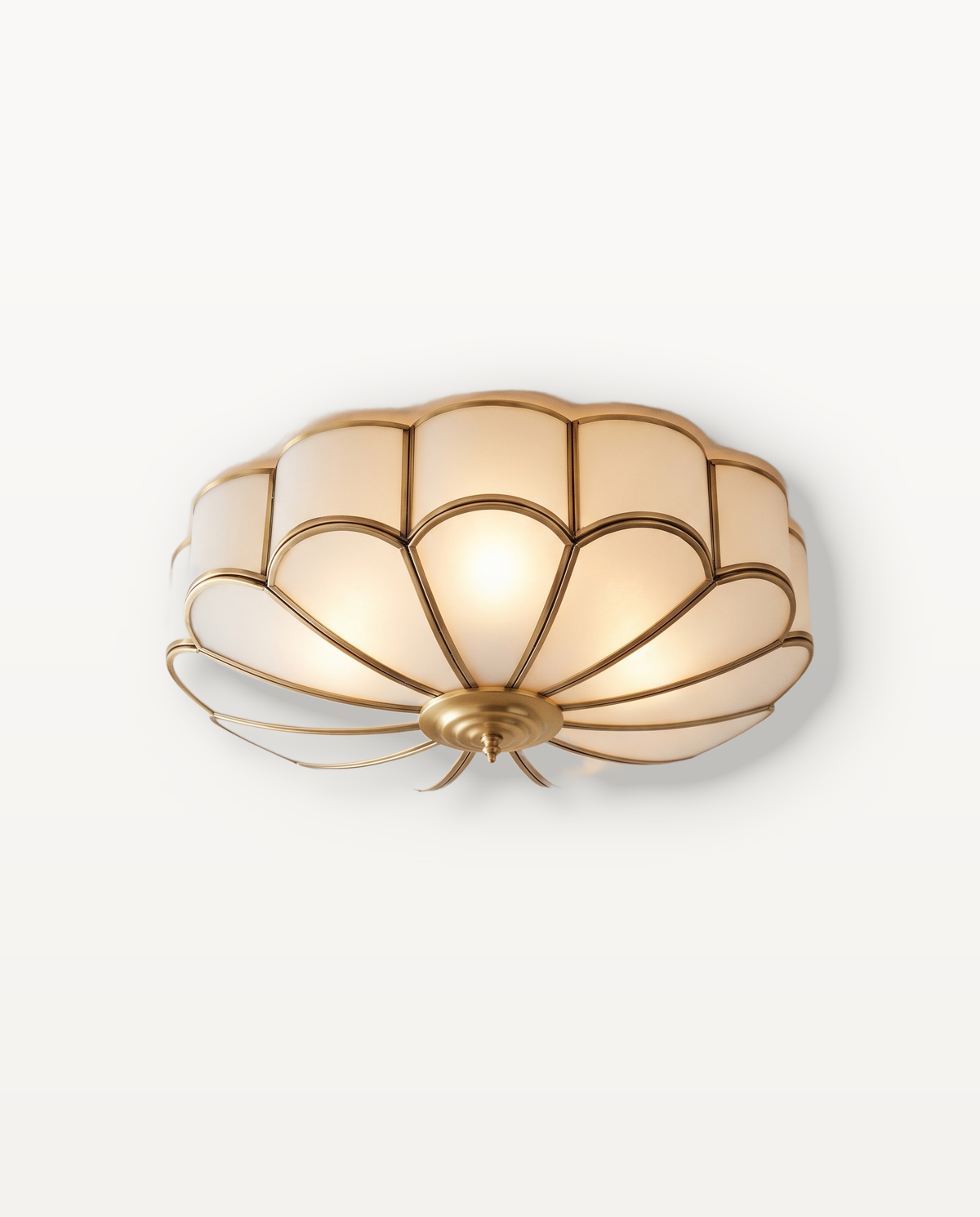 The Camellia Ceiling Light, frosted glass petals framed in brass finish, lit