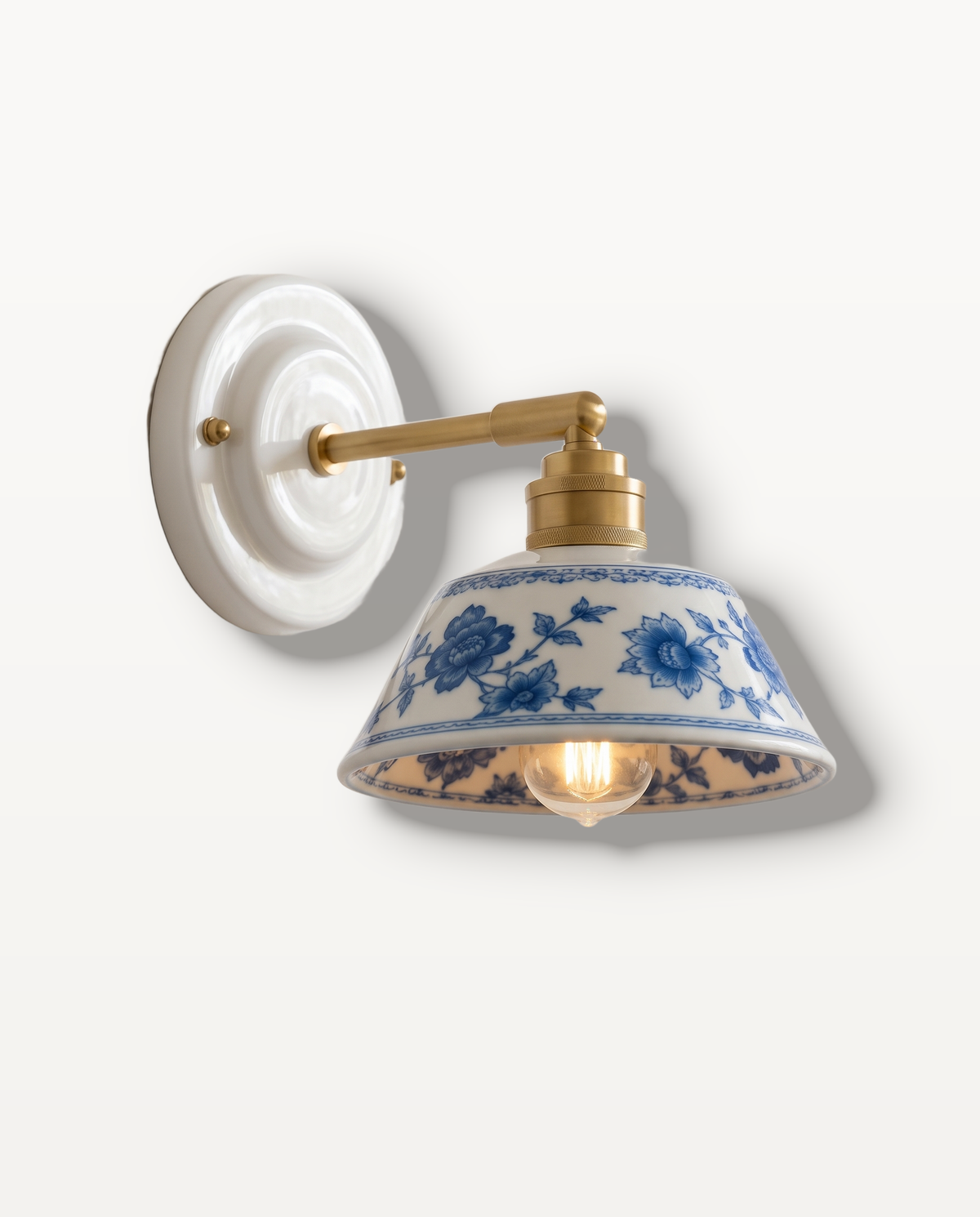 The Delft, hand-painted indigo ceramic wall light on a solid brass arm — Selden Home product photography