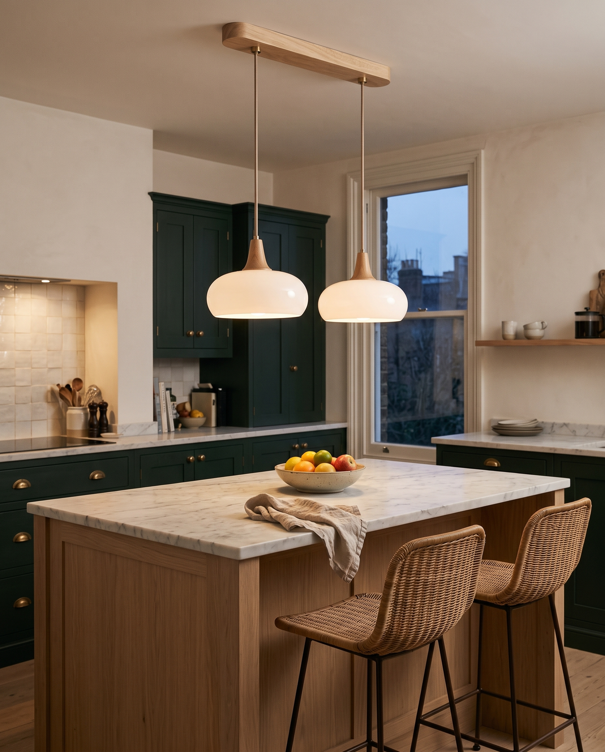 The Grove two-head pendant in white glass over a marble kitchen island