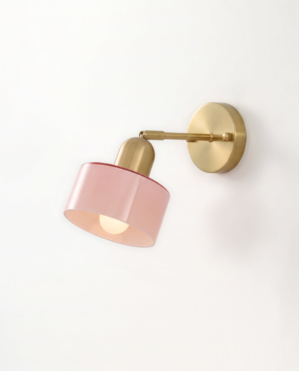 The Inkwell Wall Light with a blush pink glass shade