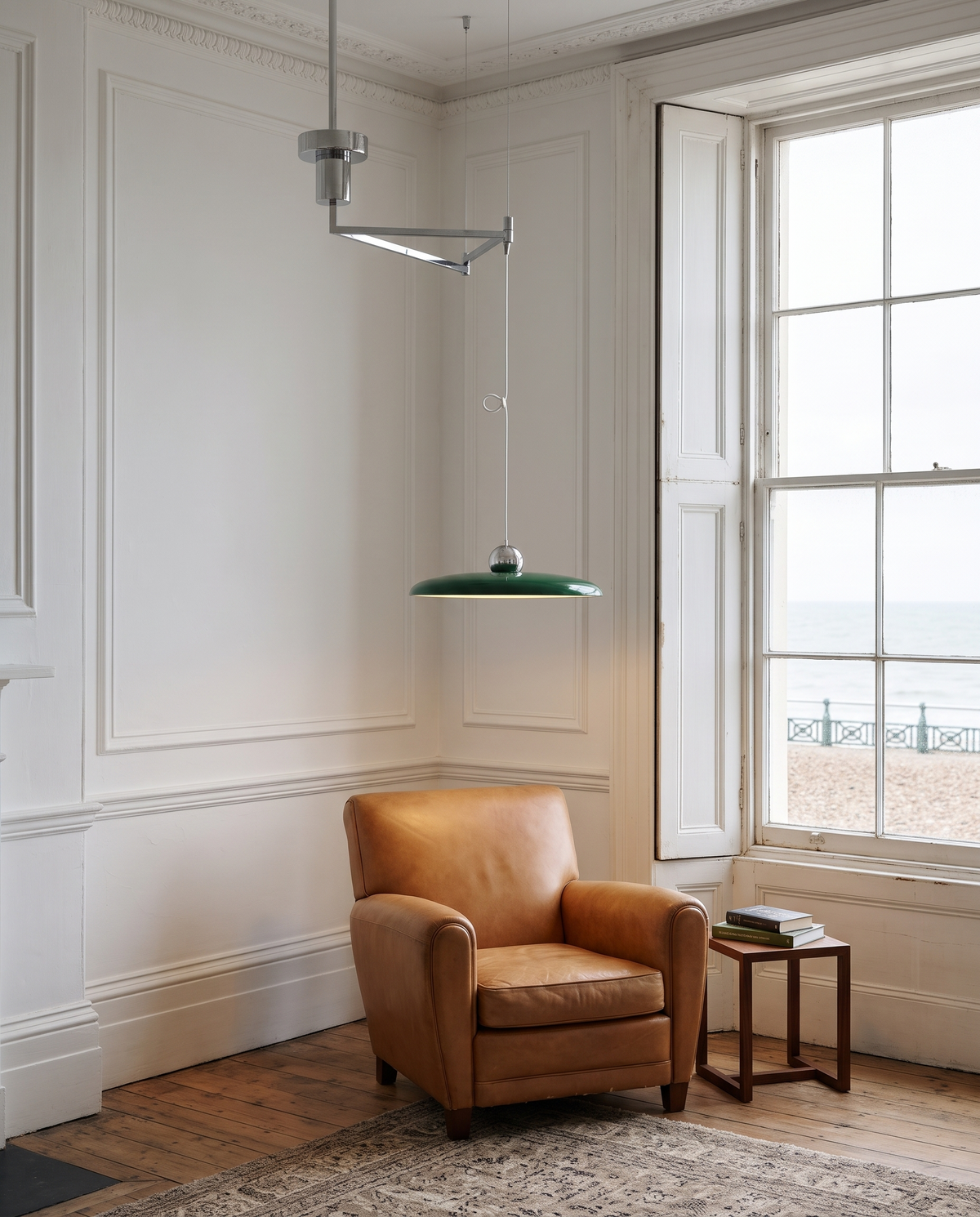 The Jib in Racing Green over a leather armchair by a seafront window