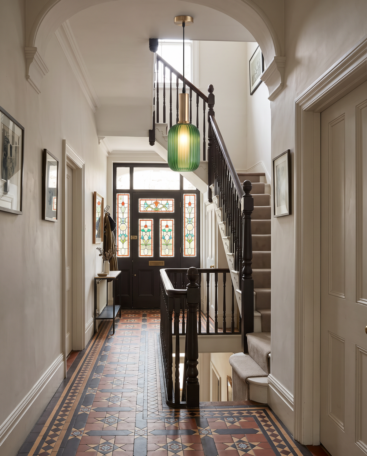 A slim green Larder in the stairwell of a Victorian hallway