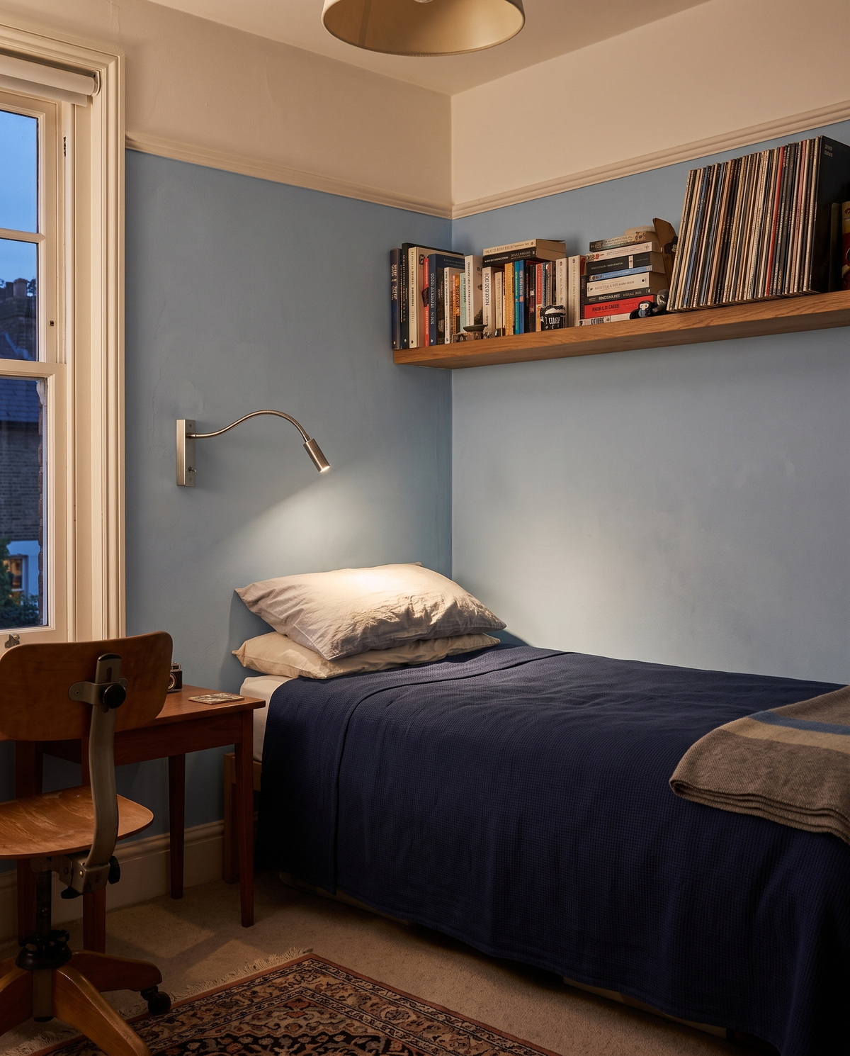 The Lectern in nickel above a single bed