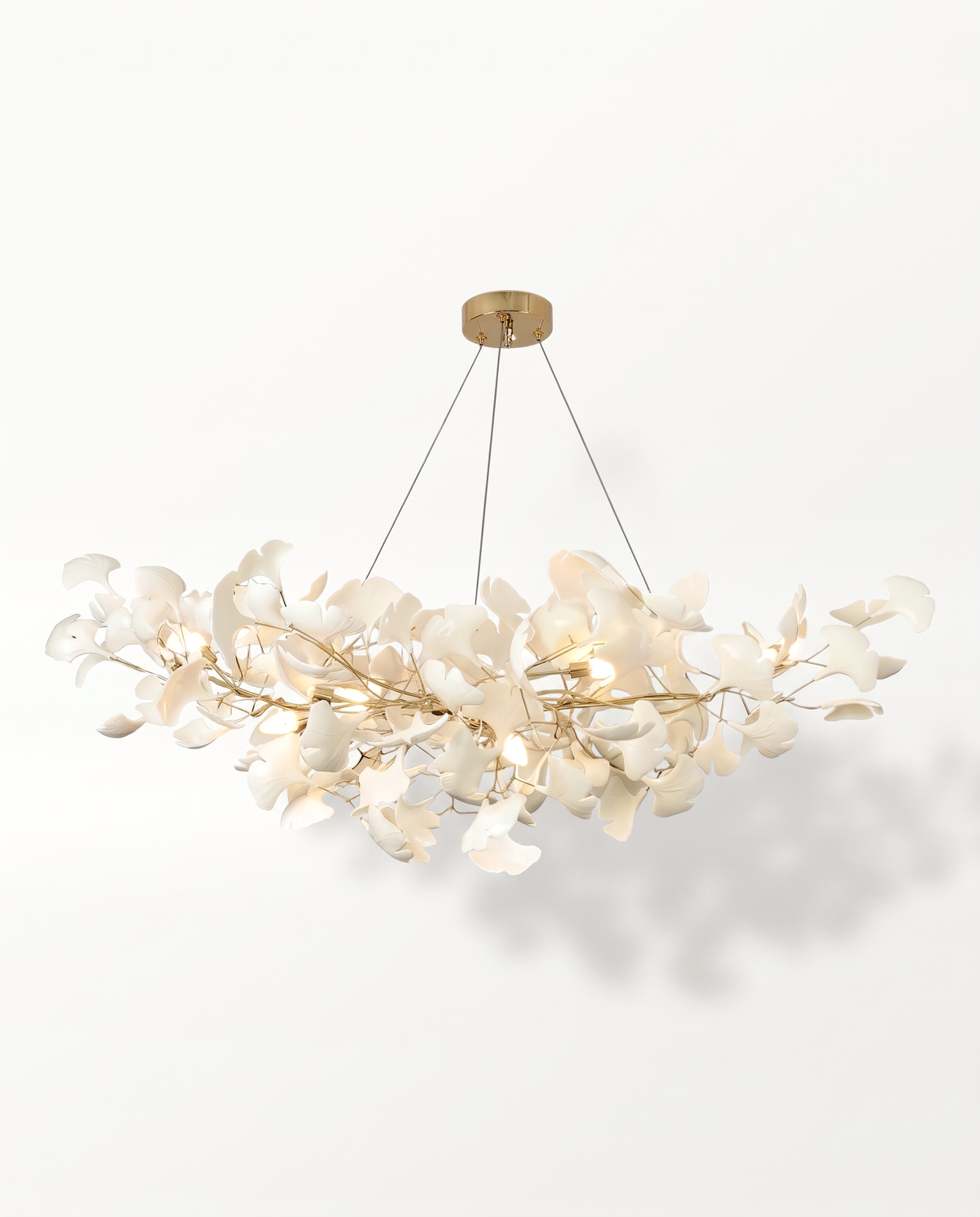 The Maidenhair Chandelier in Gilt, white porcelain ginkgo leaves on fine gold branches, lit