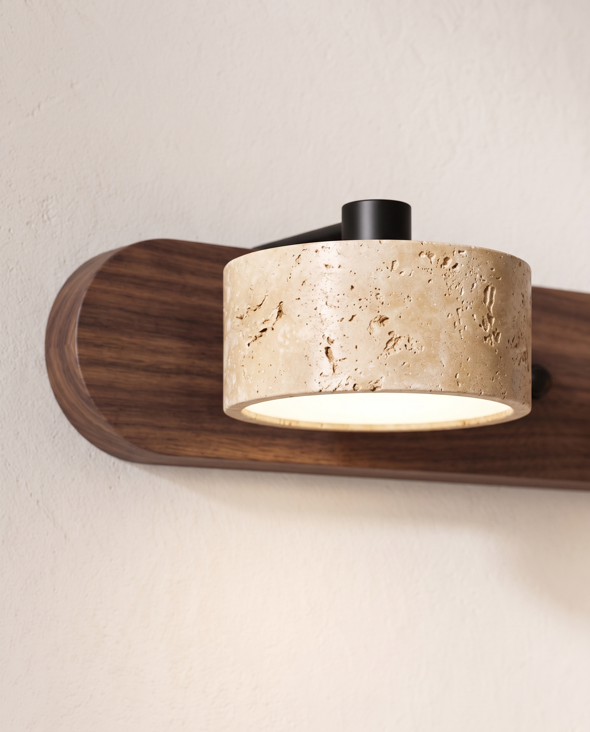 Close-up of a travertine light on the walnut bar of The Mantel