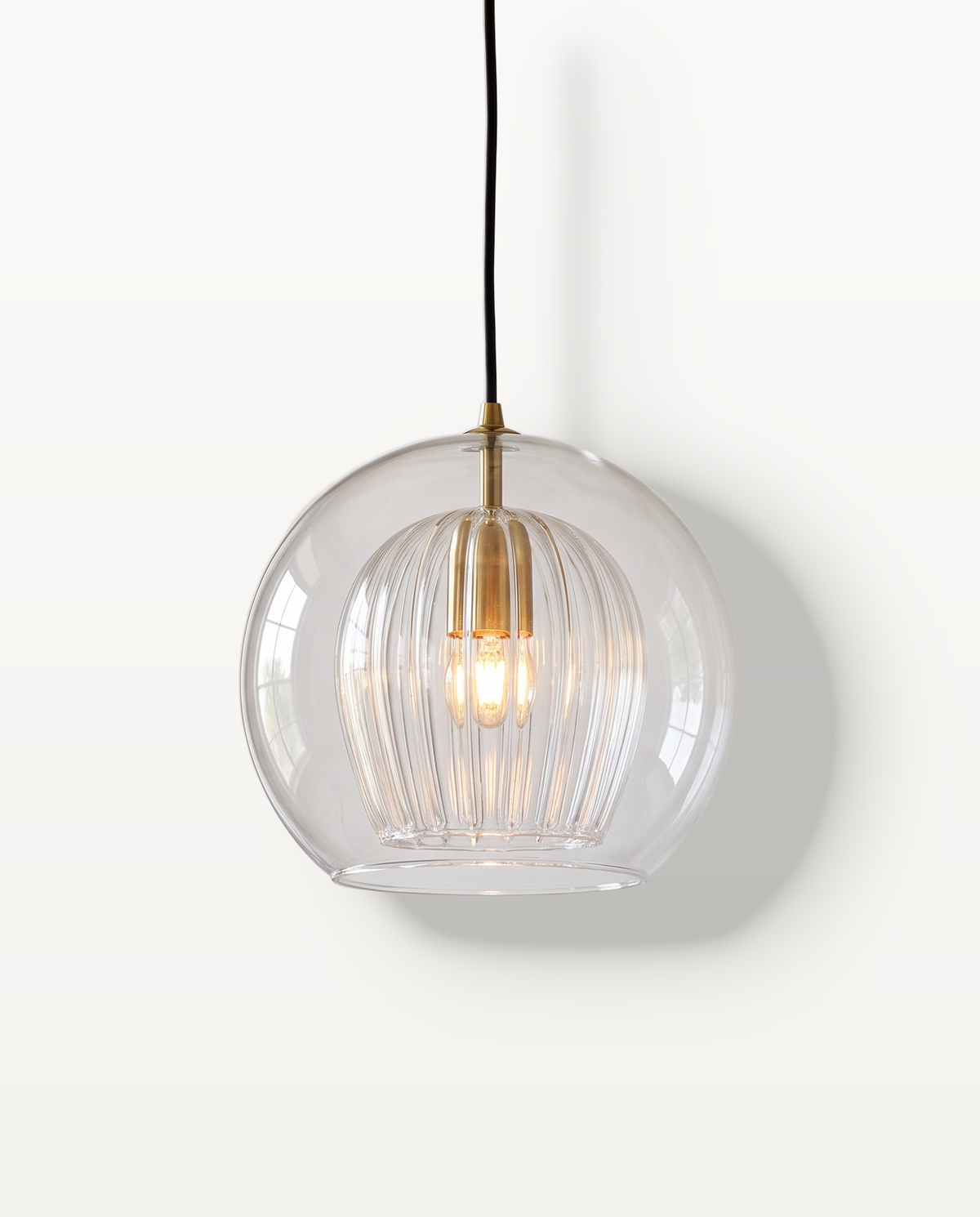The Nest Pendant, 20 cm, clear glass globe with a ribbed inner shade, lit