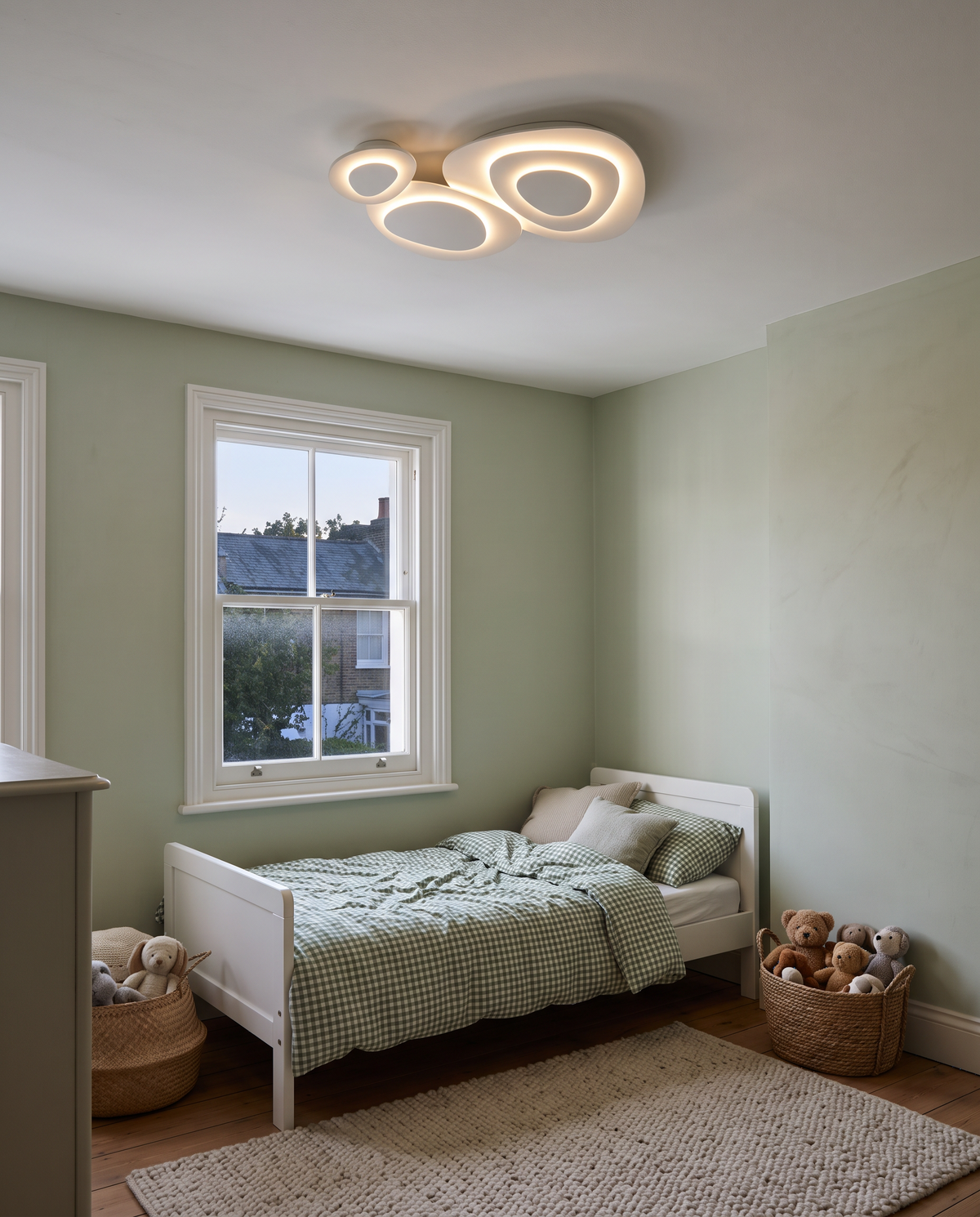 The Nimbus cloud ceiling light in a sage green children’s bedroom