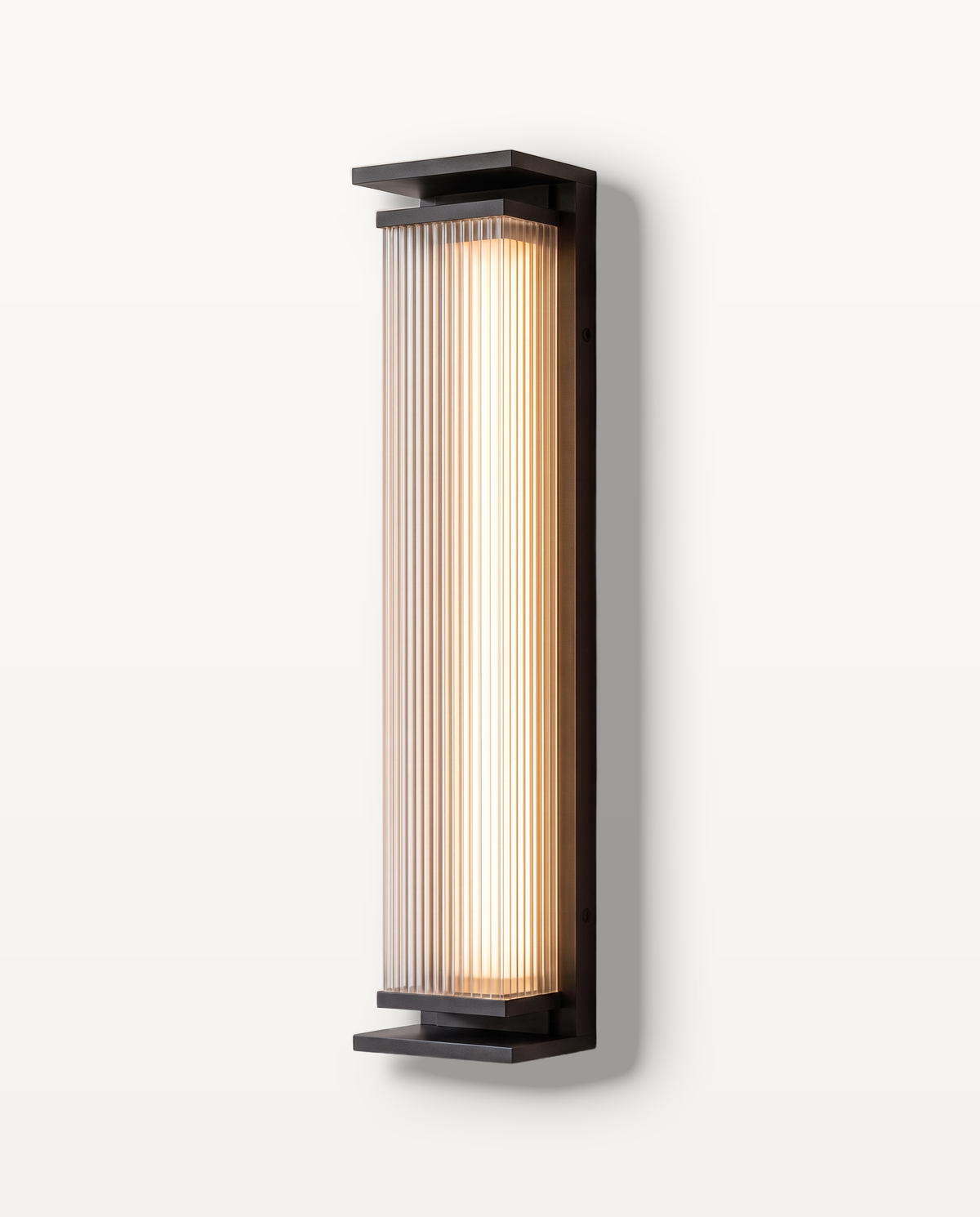 The Obelisk outdoor wall light, a fluted column in a black frame, on a limewashed wall
