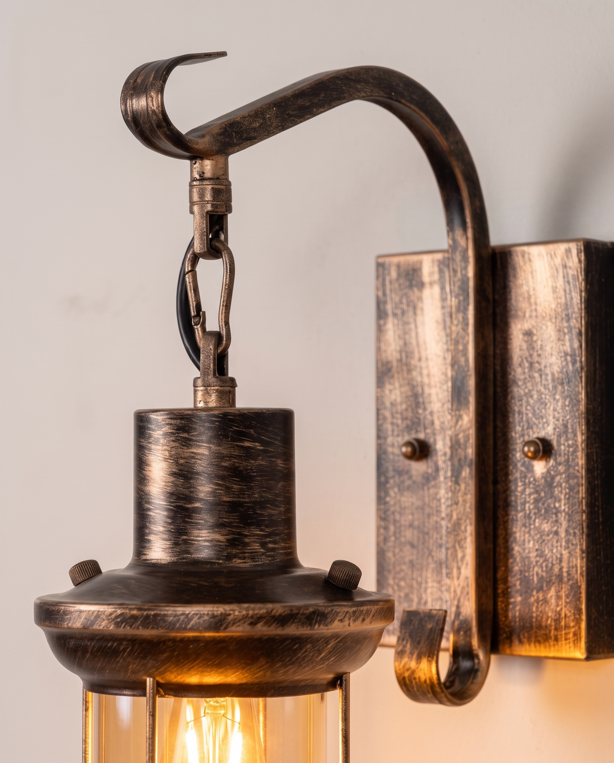 Close-up of the curled hook arm and wall plate of The Ostler