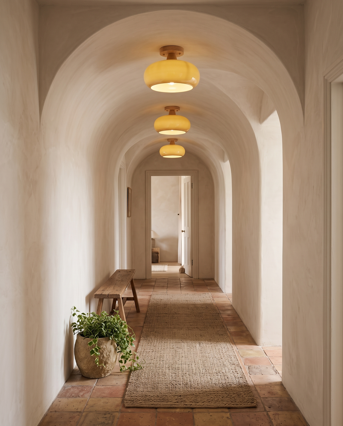 Three Pebble lights along an arched corridor