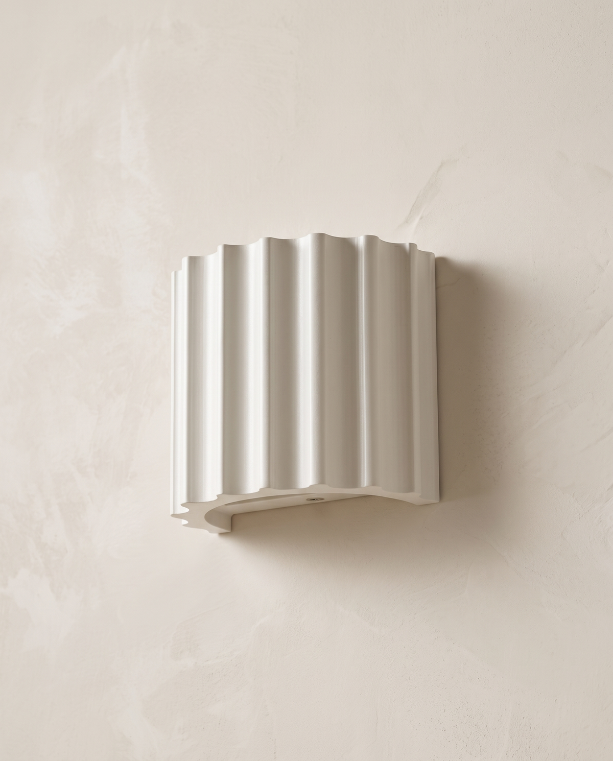 The Pleat, white fluted wall light detail on lime-washed plaster wall — Selden Home product photography