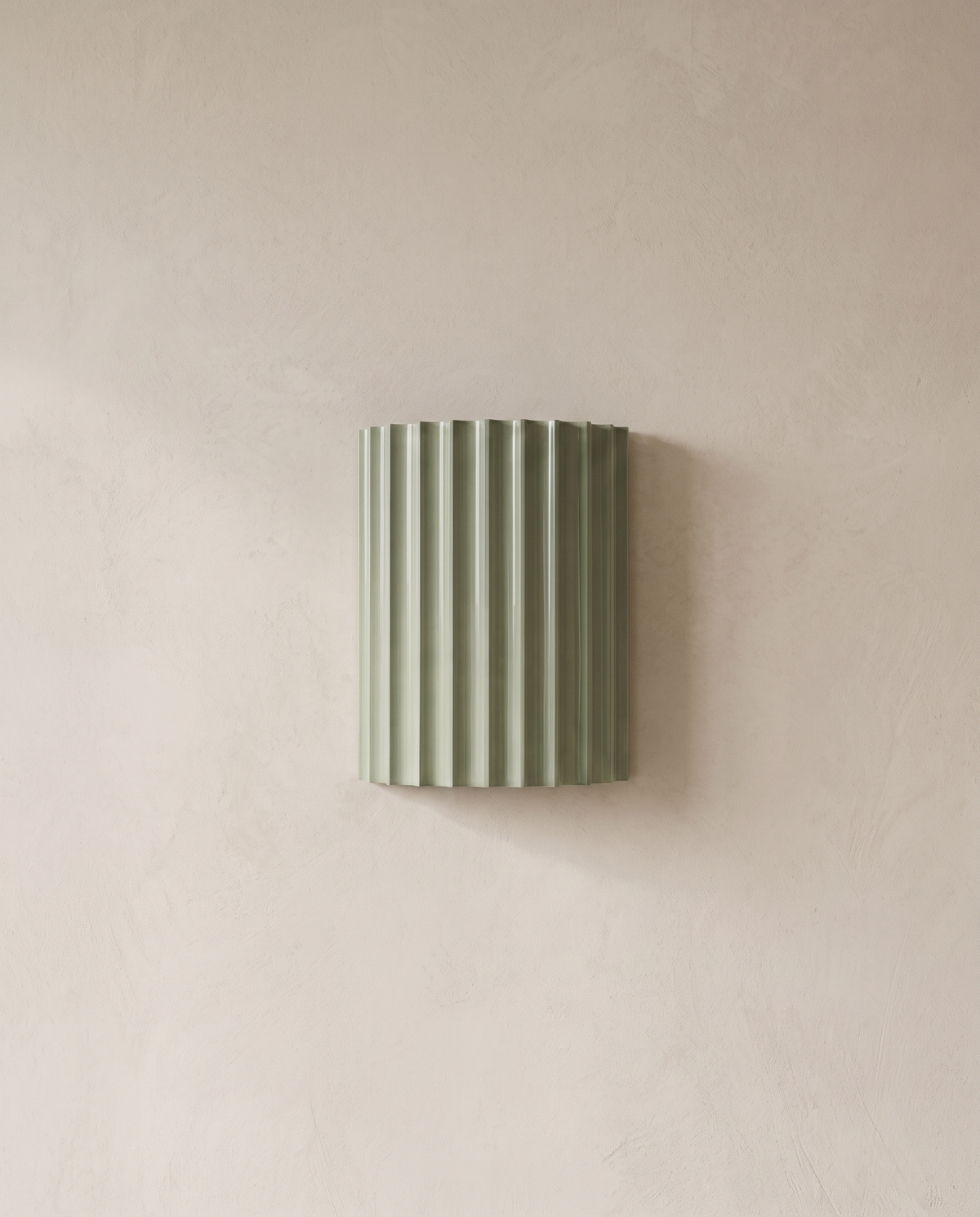The Pleat, green fluted wall light on lime-washed plaster wall — Selden Home product photography