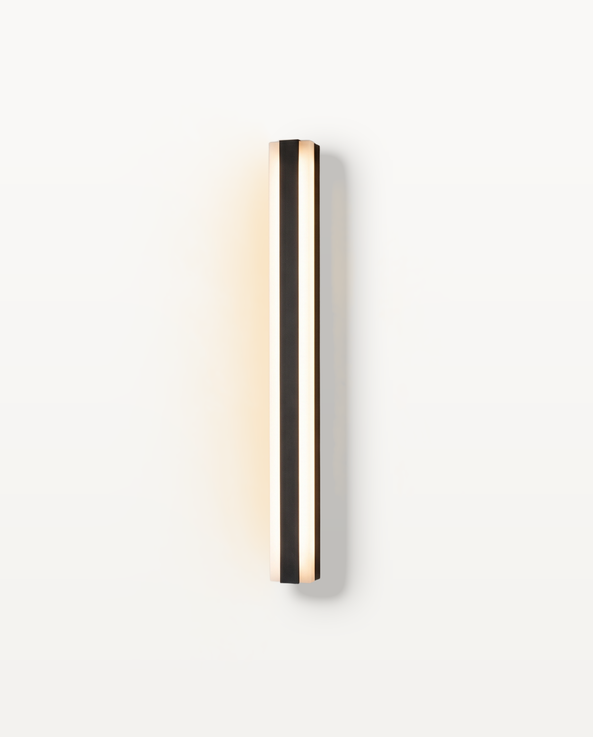 The Sentry outdoor wall light, a slim black aluminium bar glowing on both edges, on a limewashed wall