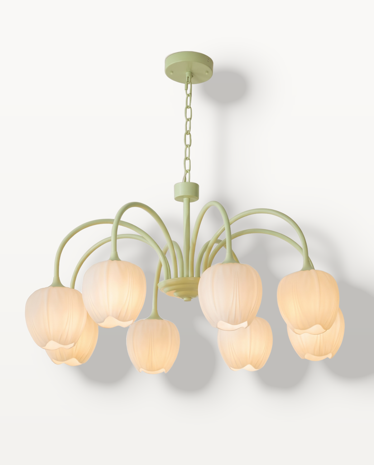 The Snowdrop Chandelier in Pistachio & Opal, opal glass tulip shades on curved arms, lit