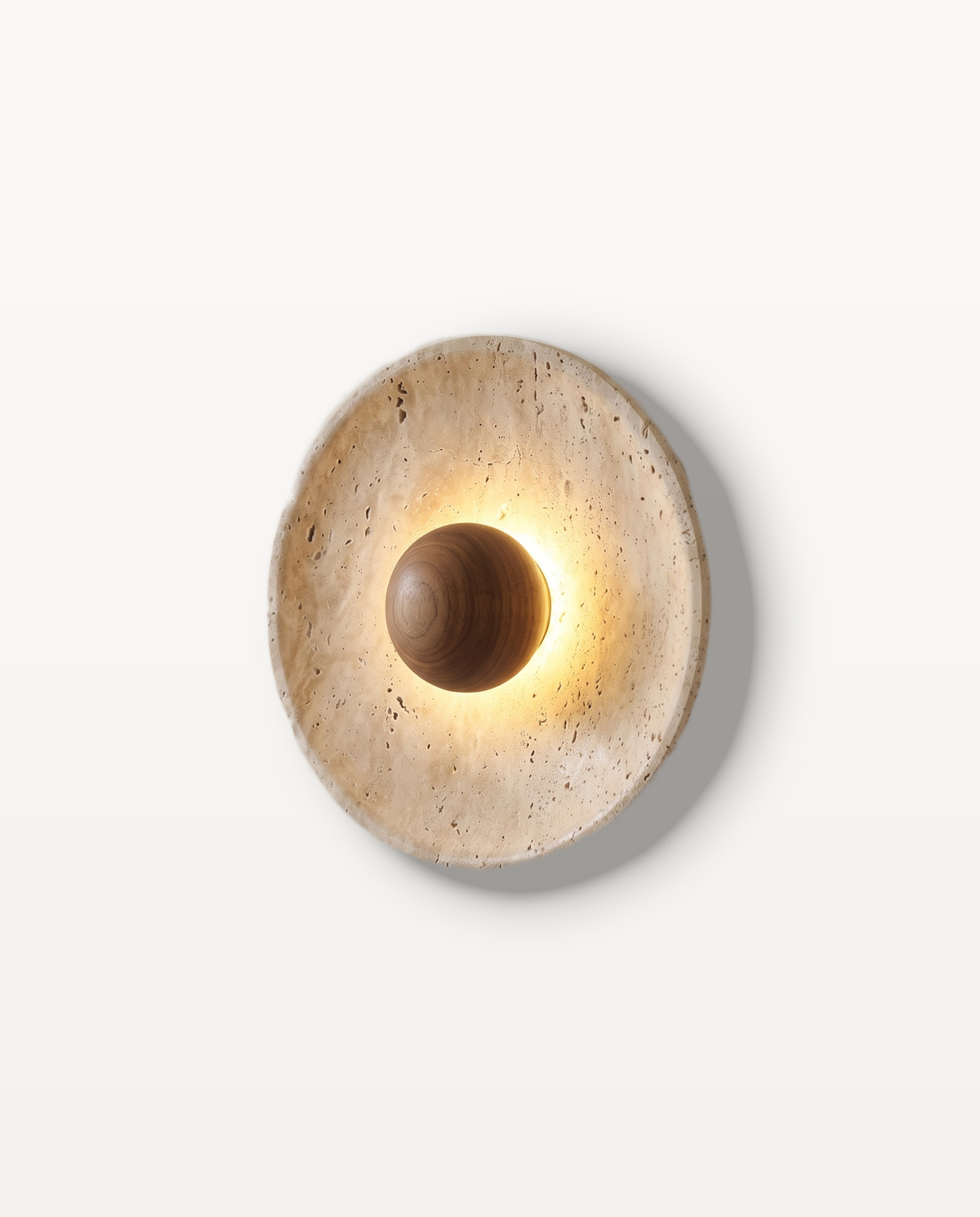 The Sundial Wall Light, travertine disc with a walnut sphere, lit