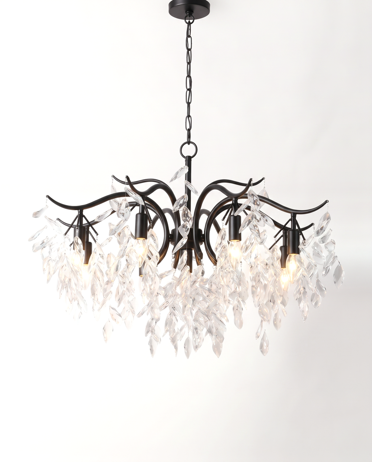 The Willow Chandelier in Jet, crystal leaves on curving black branches, lit