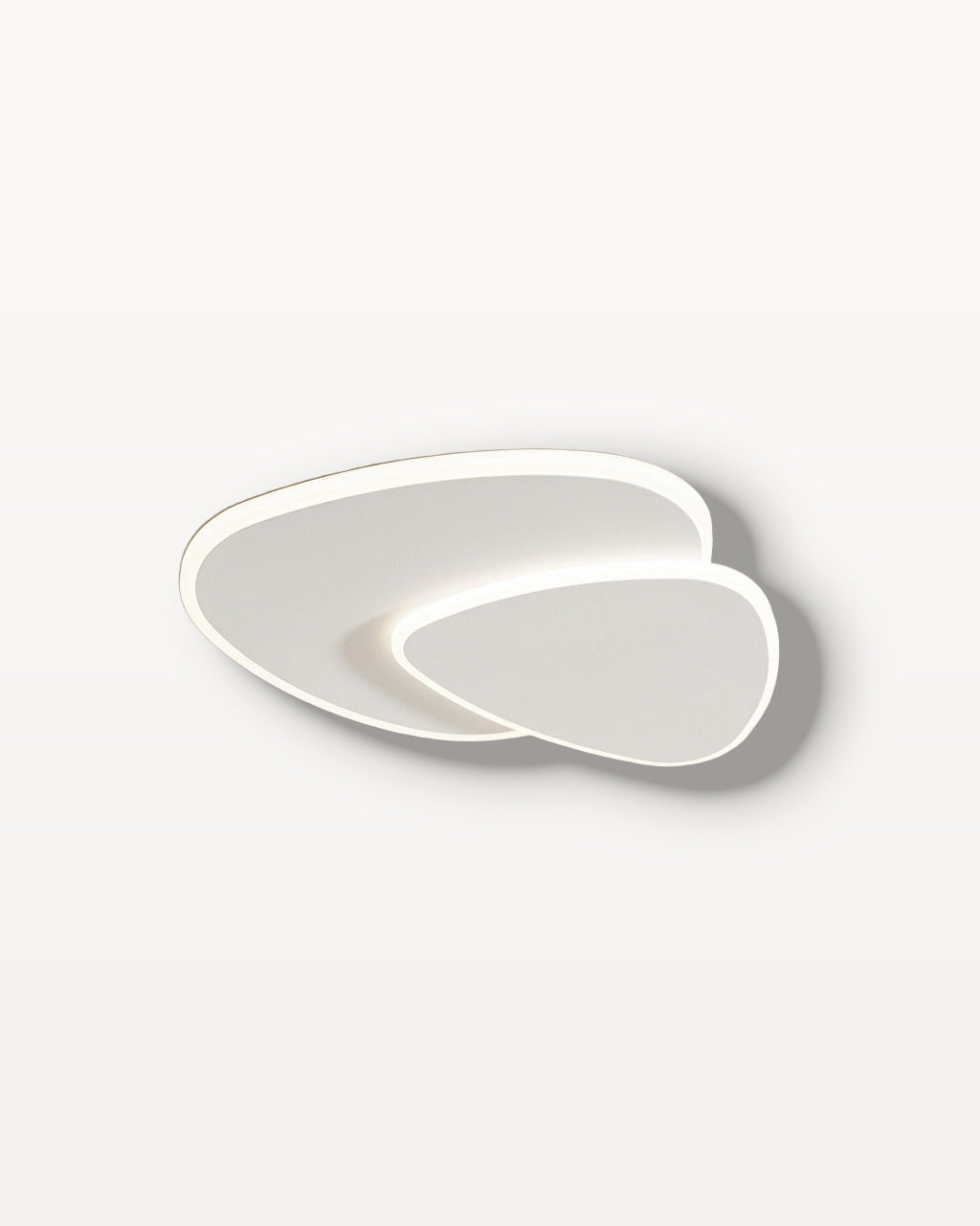 The Facet white flush-mount ceiling light, lit, against a lime-washed plaster ceiling — Selden Home product photography