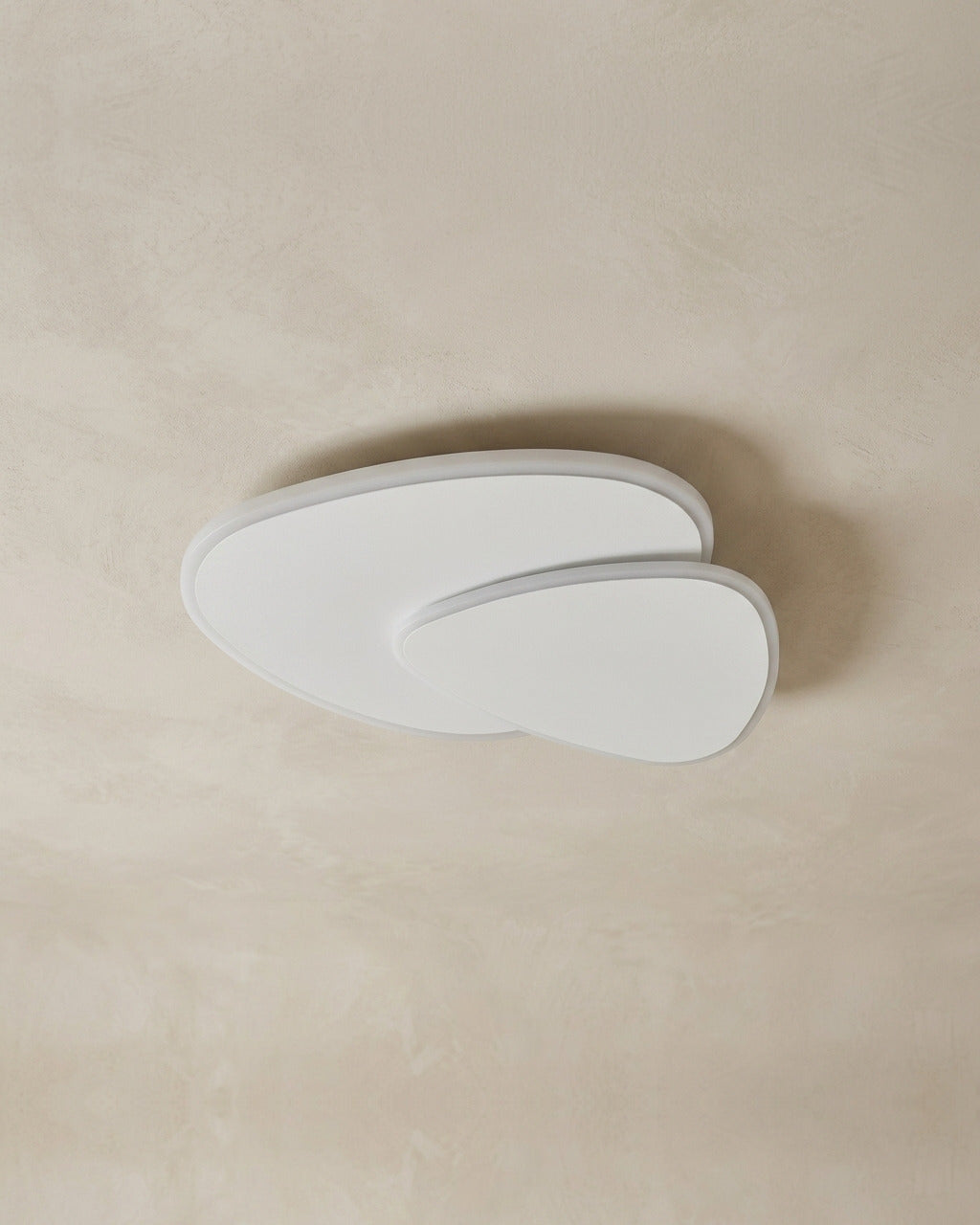 The Facet white flush-mount ceiling light, unlit, against a lime-washed plaster ceiling — Selden Home product photography