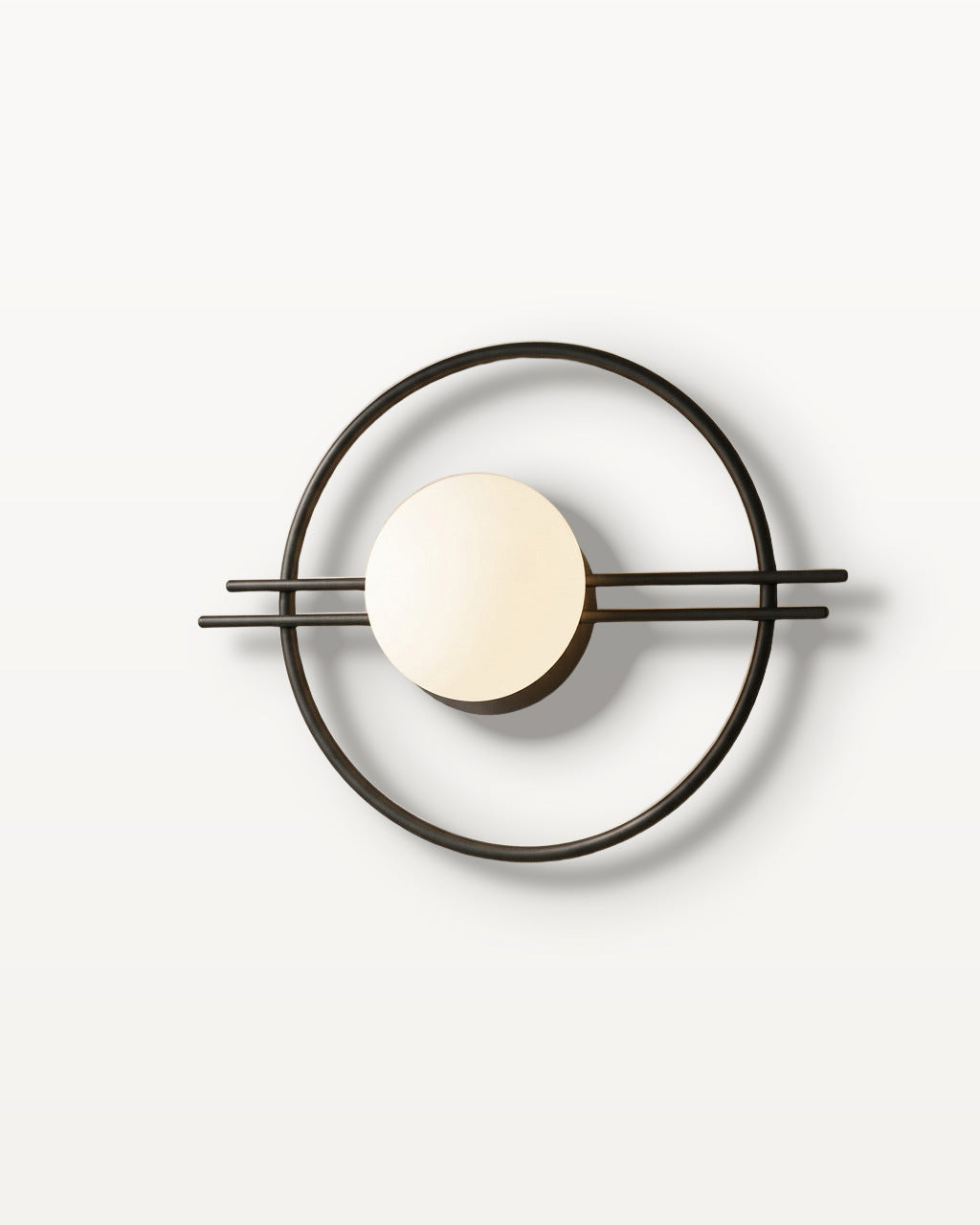 The Ring, black iron wall sconce with frosted opal glass globe, mounted on plaster wall — Selden Home product photography