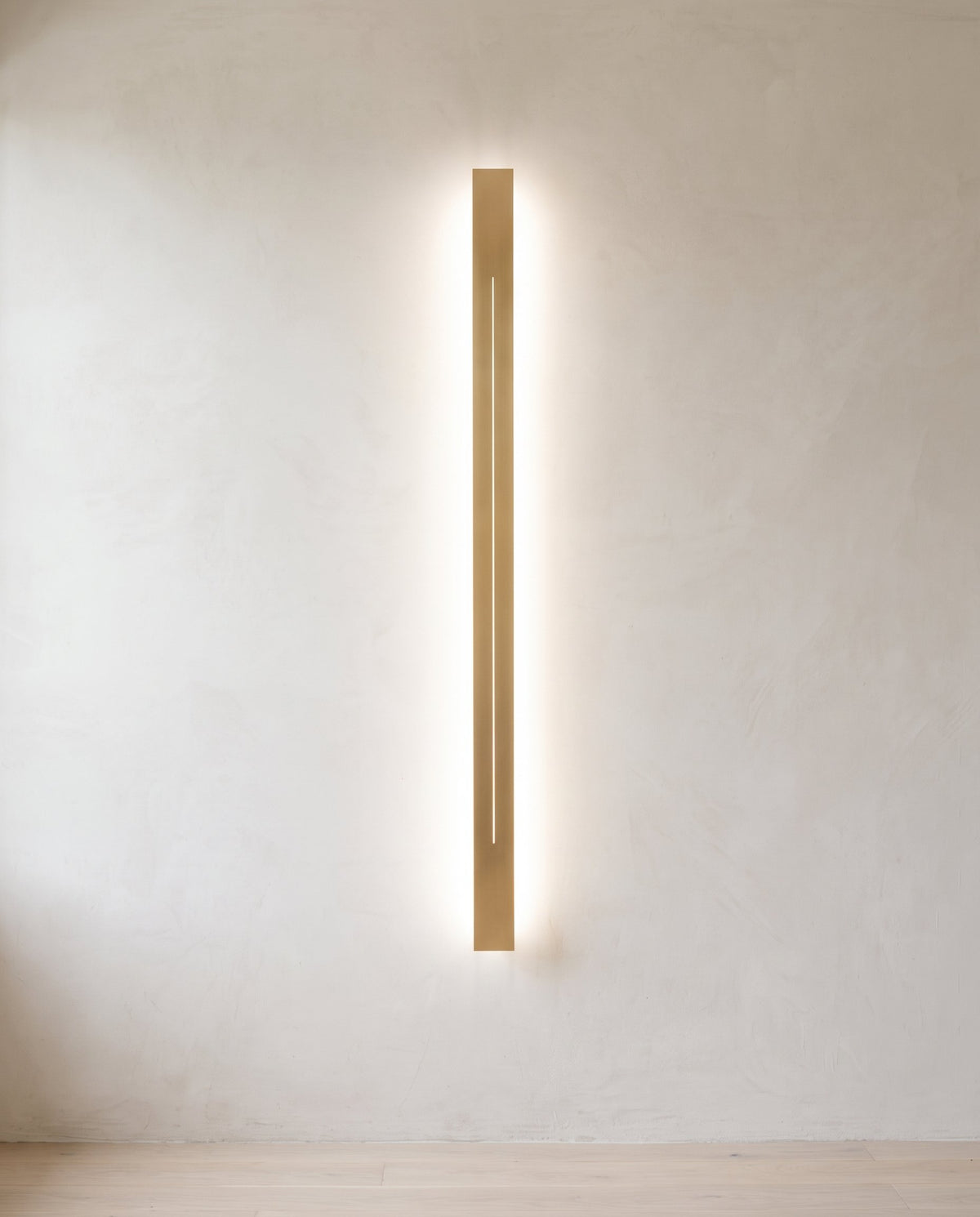 The Beam linear LED wall light, sand-finish gold face on a white body — Selden Home product photography (5)