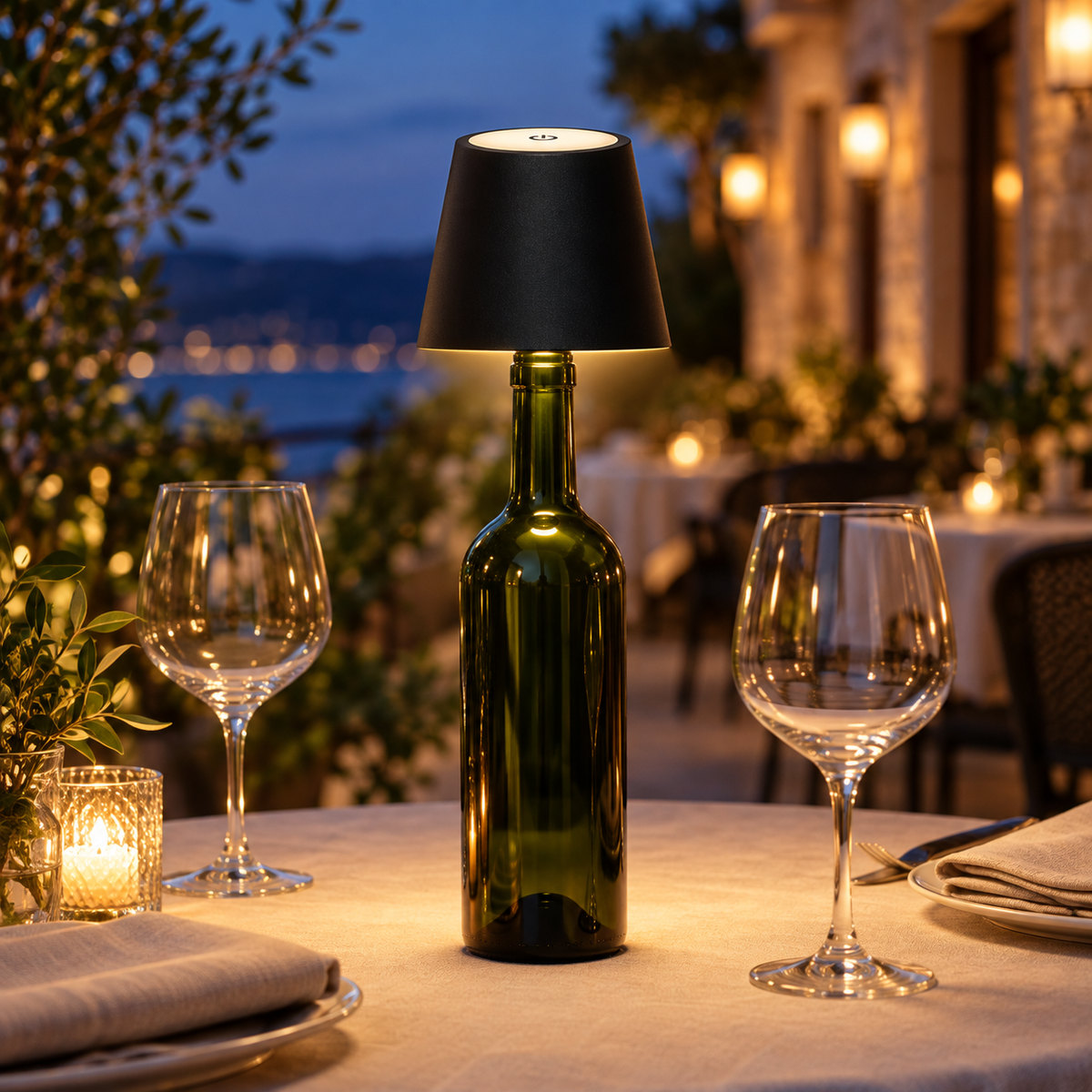 The Vesper in Jet on a green wine bottle, lighting a dinner table at night