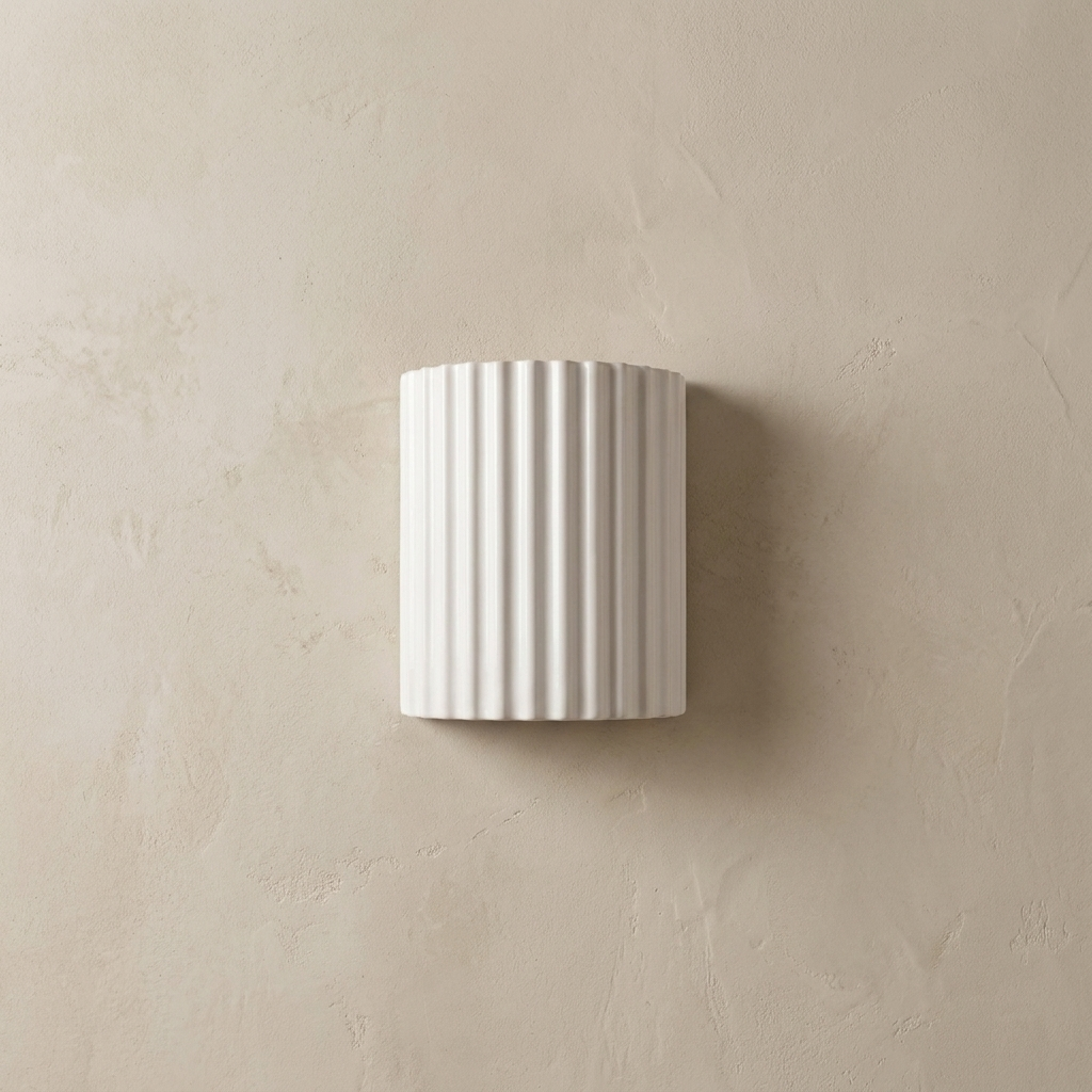 The Pleat, white fluted wall light in situ on lime-washed plaster wall — Selden Home product photography