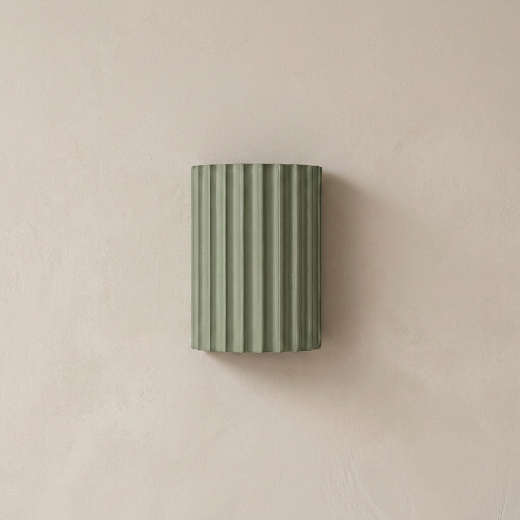 The Pleat, green fluted wall light in situ on lime-washed plaster wall — Selden Home product photography