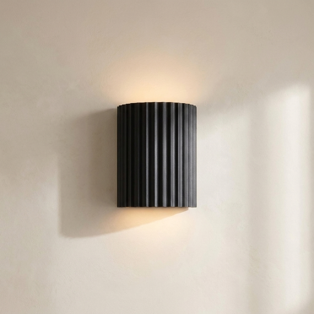 The Pleat, dark grey fluted wall light in situ on lime-washed plaster wall — Selden Home product photography