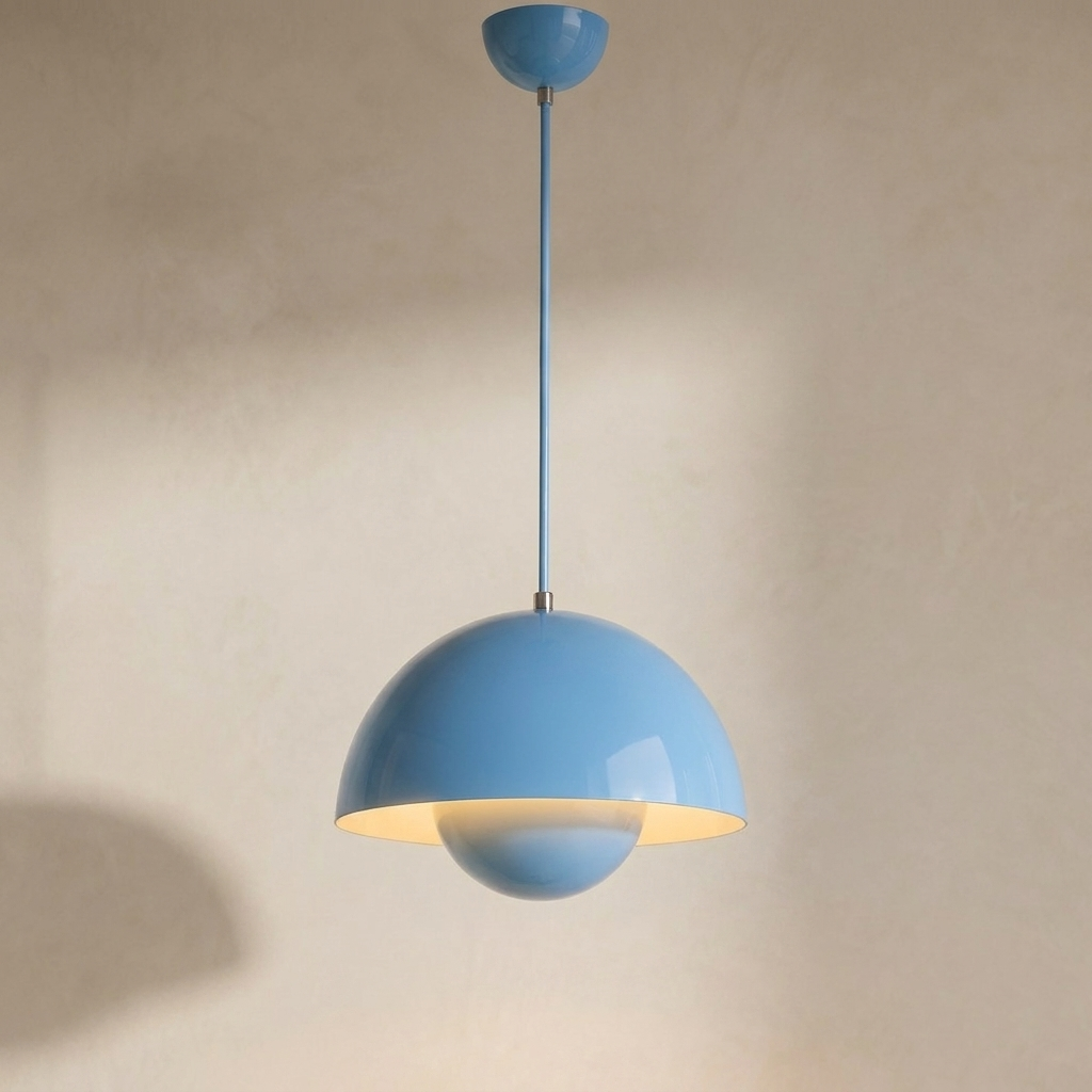 The Bonnet blue mushroom pendant light, lit, hanging in front of a lime-washed plaster wall — Selden Home product photography