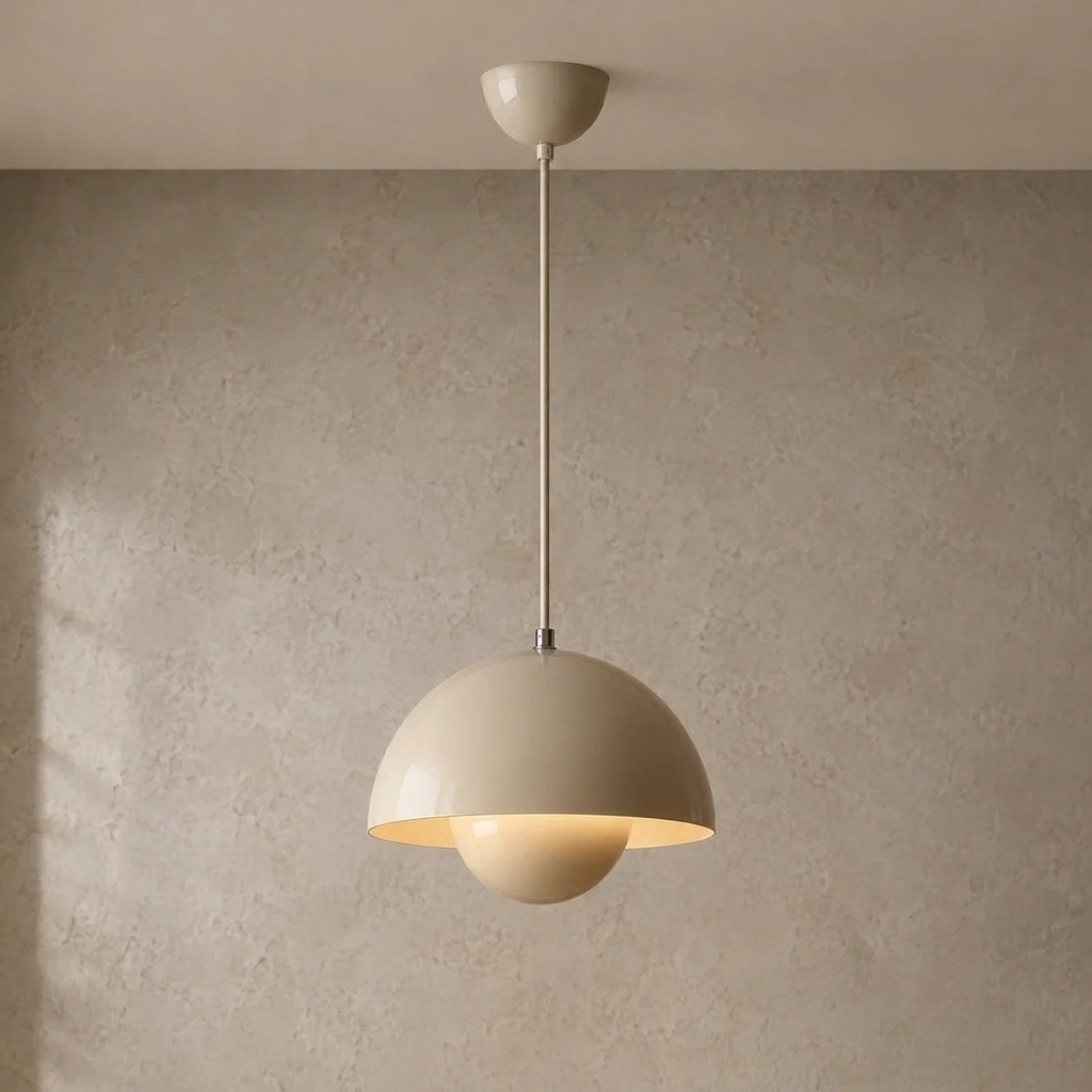 The Bonnet grey mushroom pendant light, lit, hanging in front of a lime-washed plaster wall — Selden Home product photography