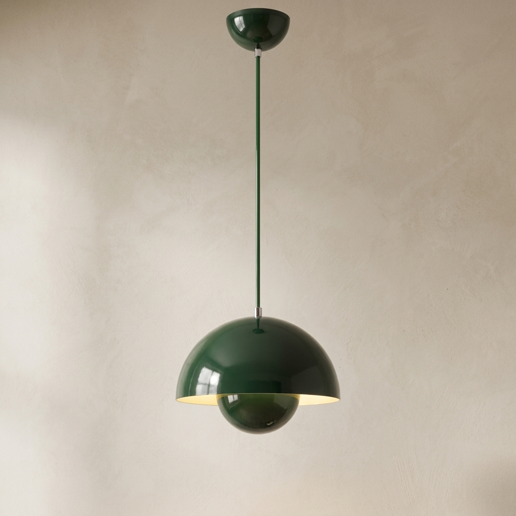 The Bonnet green mushroom pendant light, lit, hanging in front of a lime-washed plaster wall — Selden Home product photography