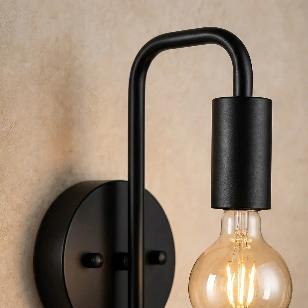 The Filament black industrial wall sconce, close-up detail of arm and bulb holder — Selden Home product photography