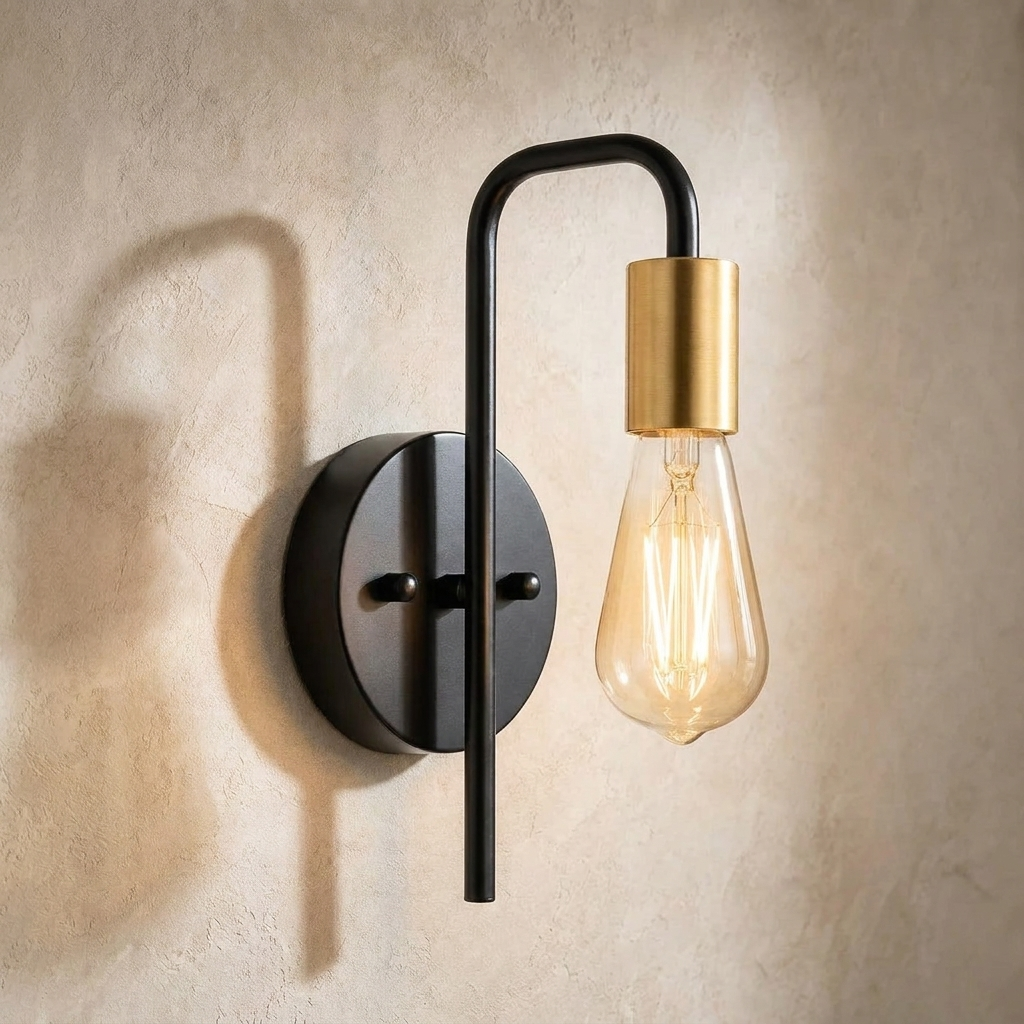 The Filament black and gold industrial wall sconce, close-up detail of arm and bulb holder — Selden Home product photography