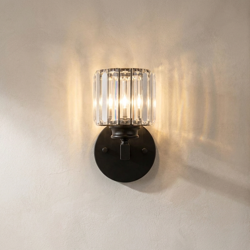 The Prism black art deco crystal wall sconce, lit, mounted on a lime-washed plaster wall — Selden Home product photography