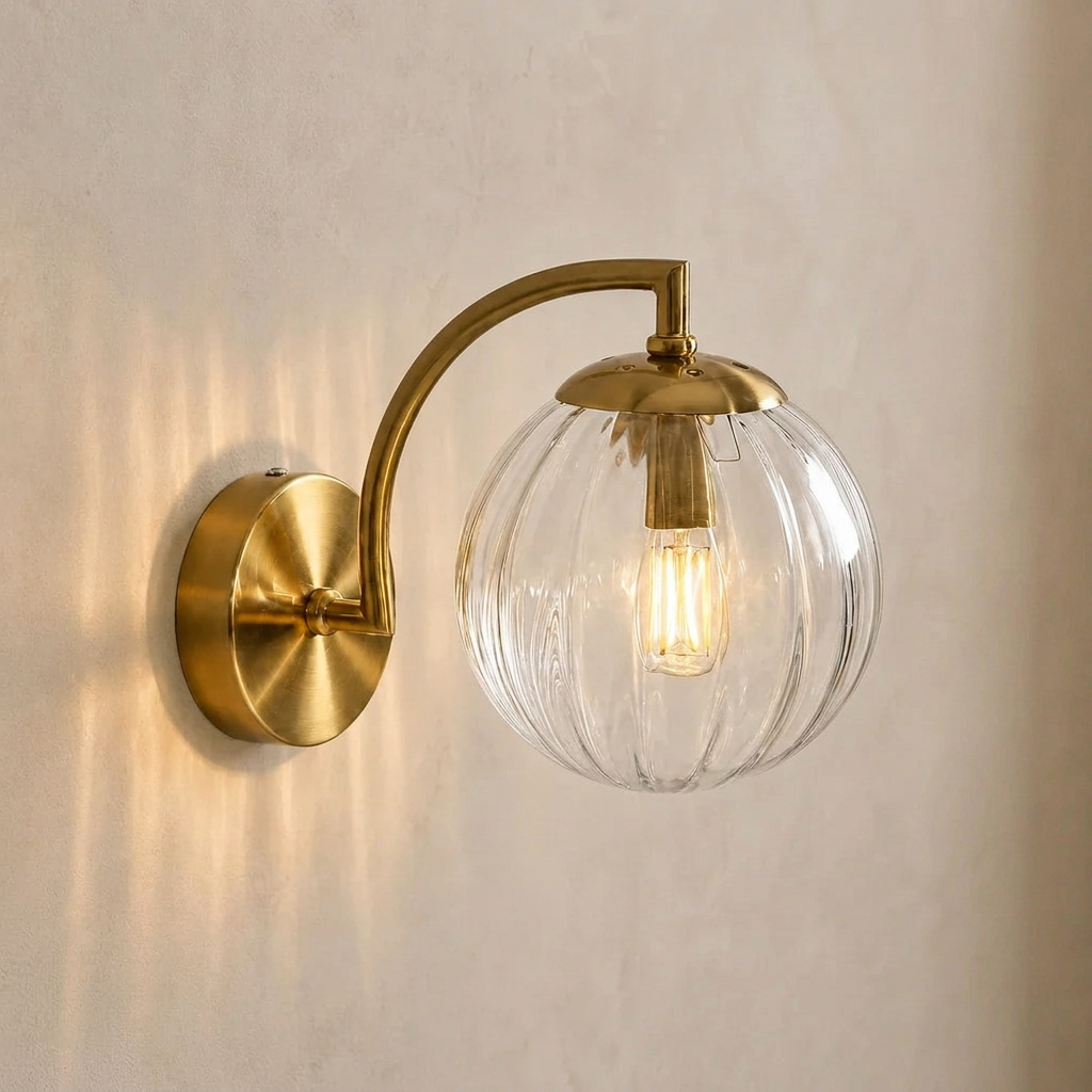 The Bloom, ribbed glass wall sconce, clear glass on gold arm, mounted on plaster wall — Selden Home product photography