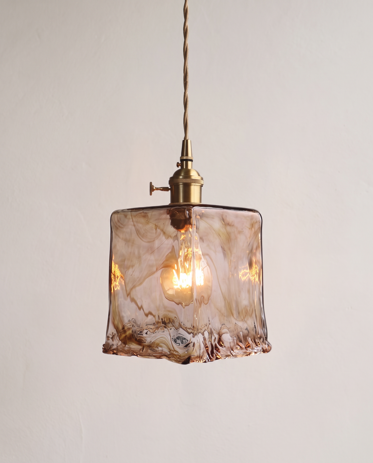 The Tumbler Pendant – Prism, textured amber glass with a brass holder