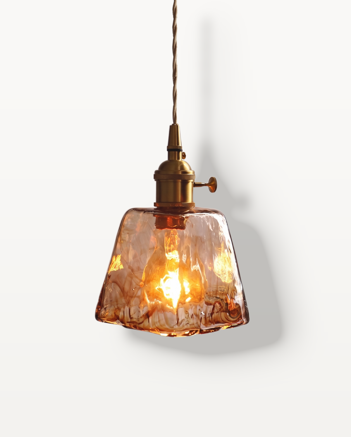 The Tumbler Pendant – Bell, textured amber glass with a brass holder