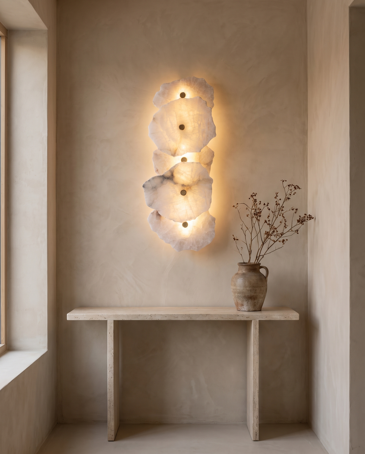 The Strata Wall Light with five heads above a travertine hallway console