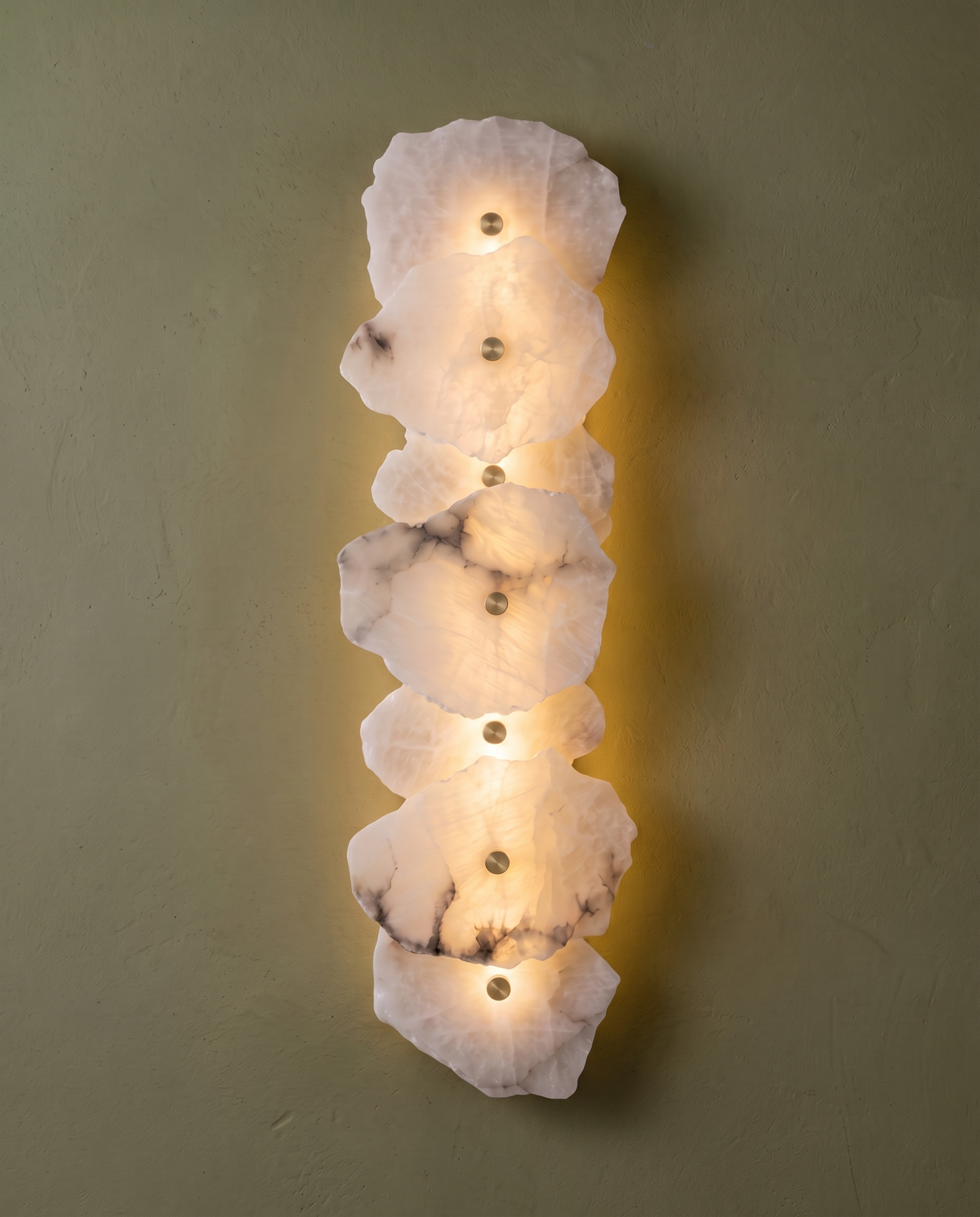 The Strata Wall Light with seven heads on an olive green wall